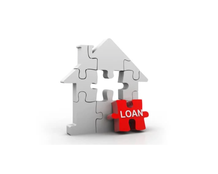 A white house-shaped puzzle with a missing piece and a red puzzle piece labeled 'LOAN' in front.