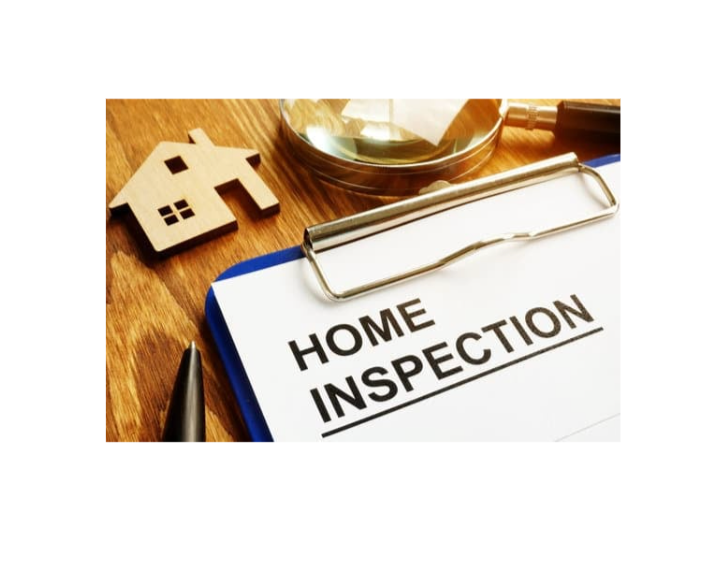 Home inspection report on a clipboard with a small wooden house model, a magnifying glass, and a pen on a wooden surface.