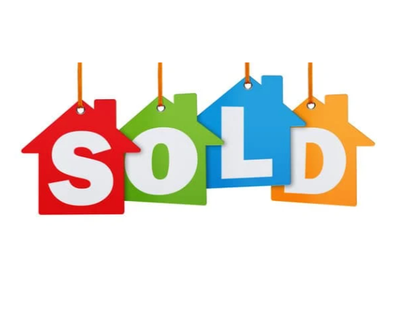 Colorful hanging tags spelling out 'SOLD' with house shapes in red, green, blue, and orange.