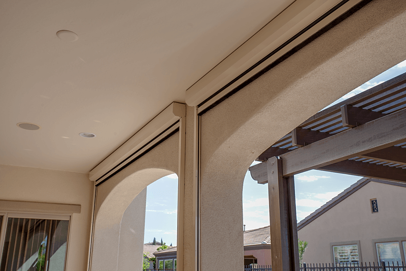 Head-rail of a light brown motorized Exterior ZIP track shade