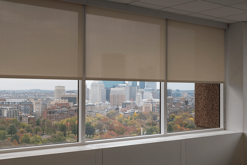A white Roller/Solar shade with a Steel chain and white fascia partially open.