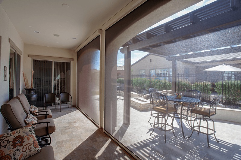 Light brown motorized Exterior ZIP track solar shade