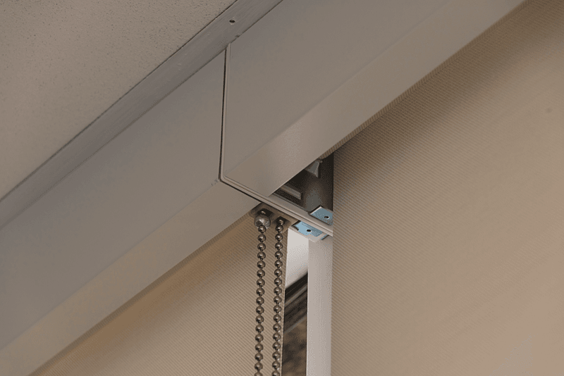 The under side of a Roller/Solar Shade with a white fascia.  Lansing Michigan