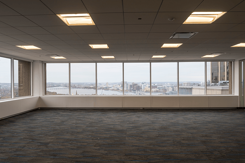 A room of white Roller/Solar shades with a Steel chain and white fascia in an office building. Lansing Michigan