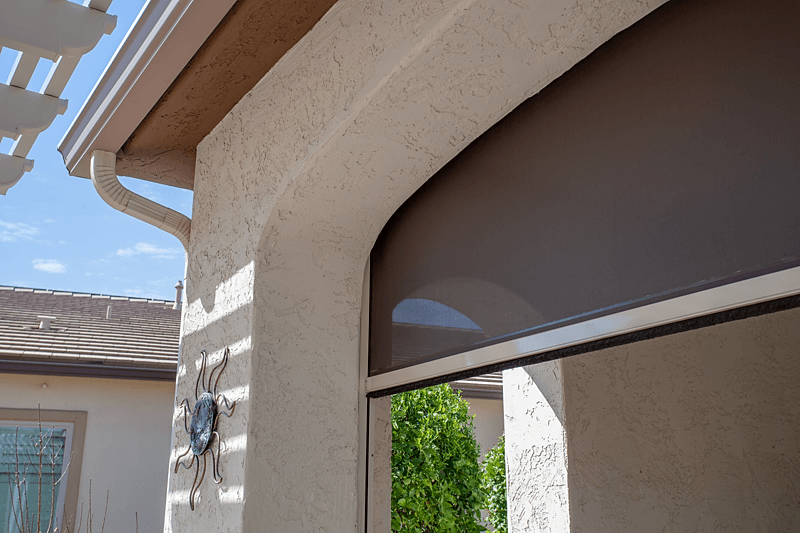 Light brown motorized Exterior ZIP track solar shade