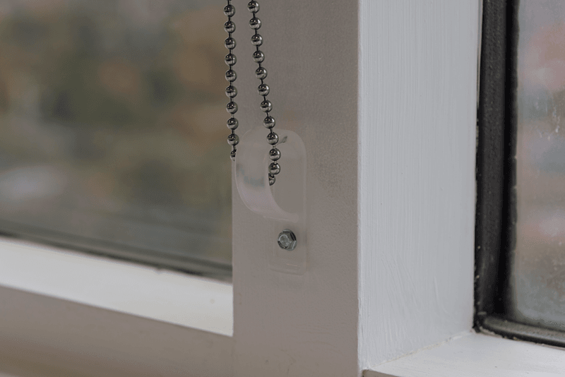 Steel Chain on a white commercial Roller/Solar Shade in an office with a valance. Lansing Michigan