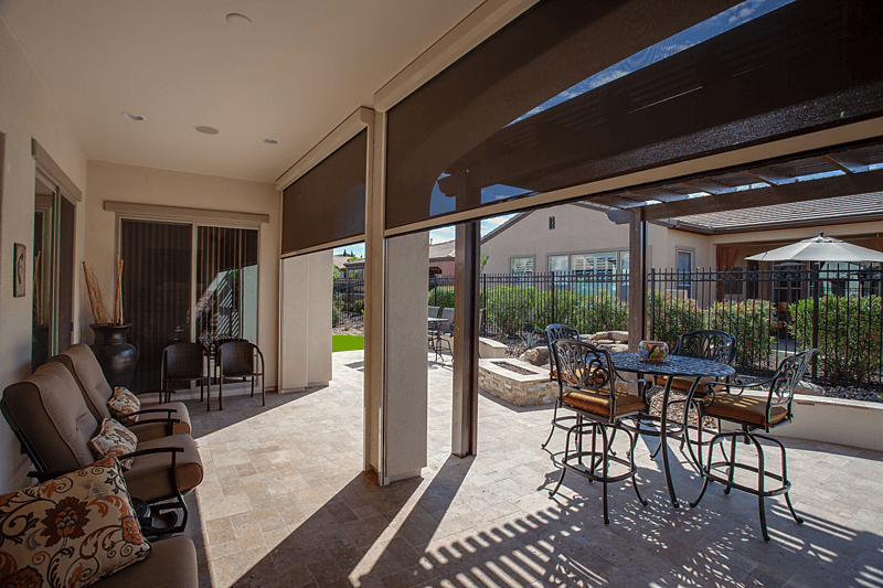 Light brown motorized Exterior ZIP track solar shade looking out