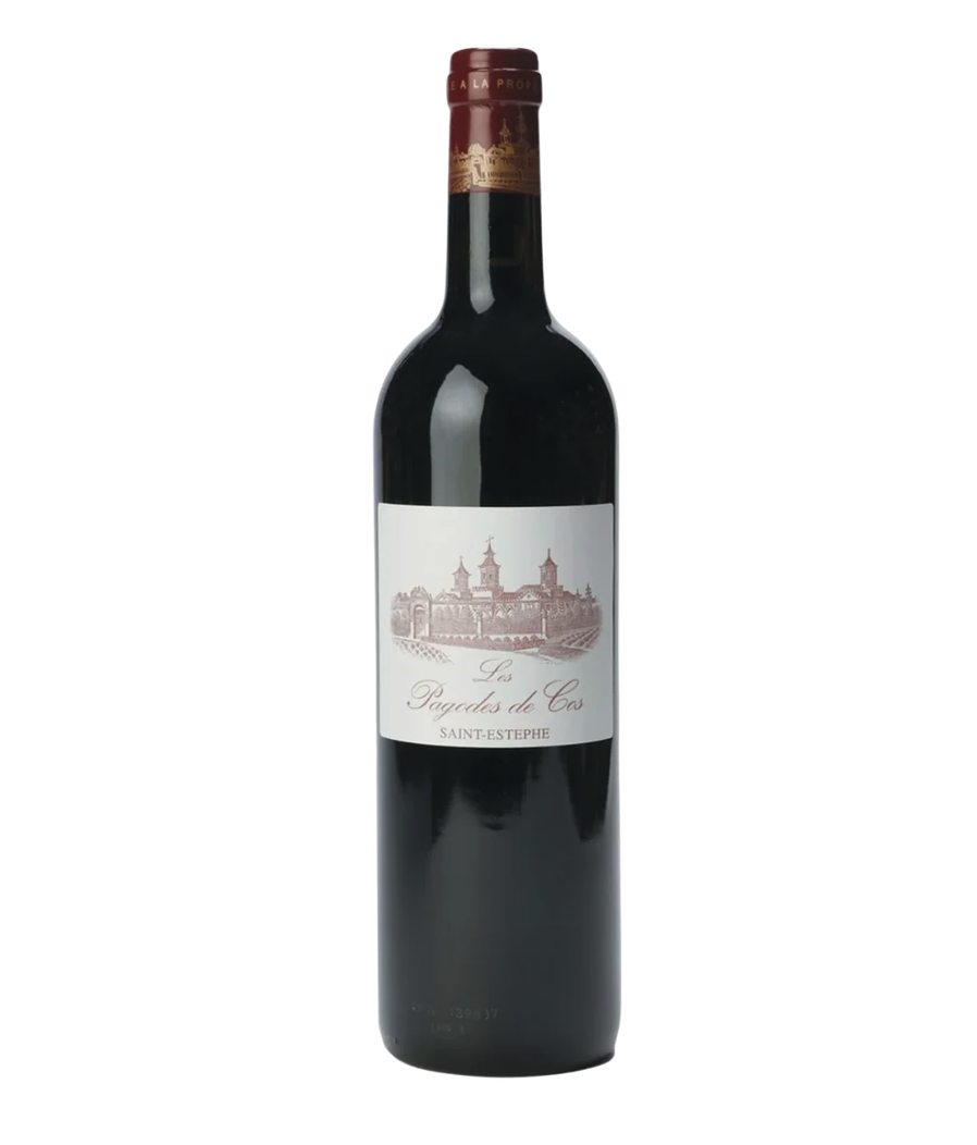 A bottle of red wine with a white label featuring a sketch of a castle and text that reads "Les Pagodes de Cos Saint-Estephe."