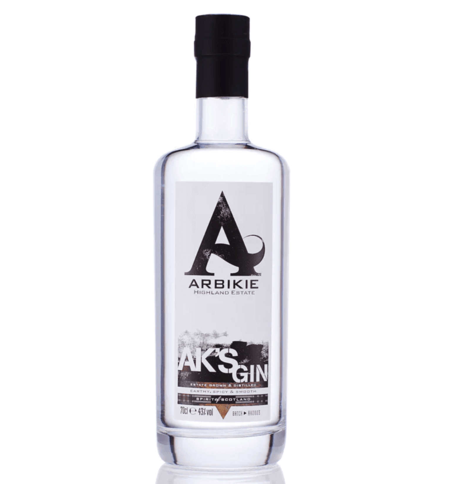 A clear bottle of Arbikie Highland Estate AK'S Gin with a black cap, featuring a black, white, and brown label with text including 'AK'S GIN,' 'Highland Estate,' and details about the spirit's botanical ingredients.