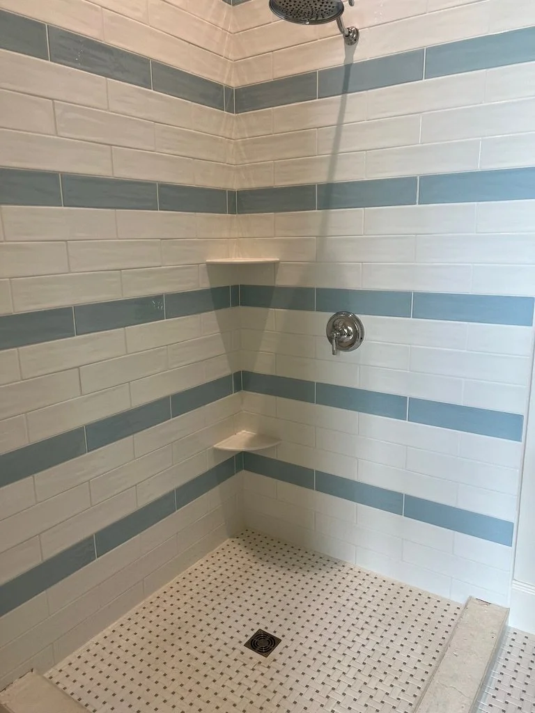 Custom Subway Tile Shower with Shelves and  a Mosaic Tile Floor