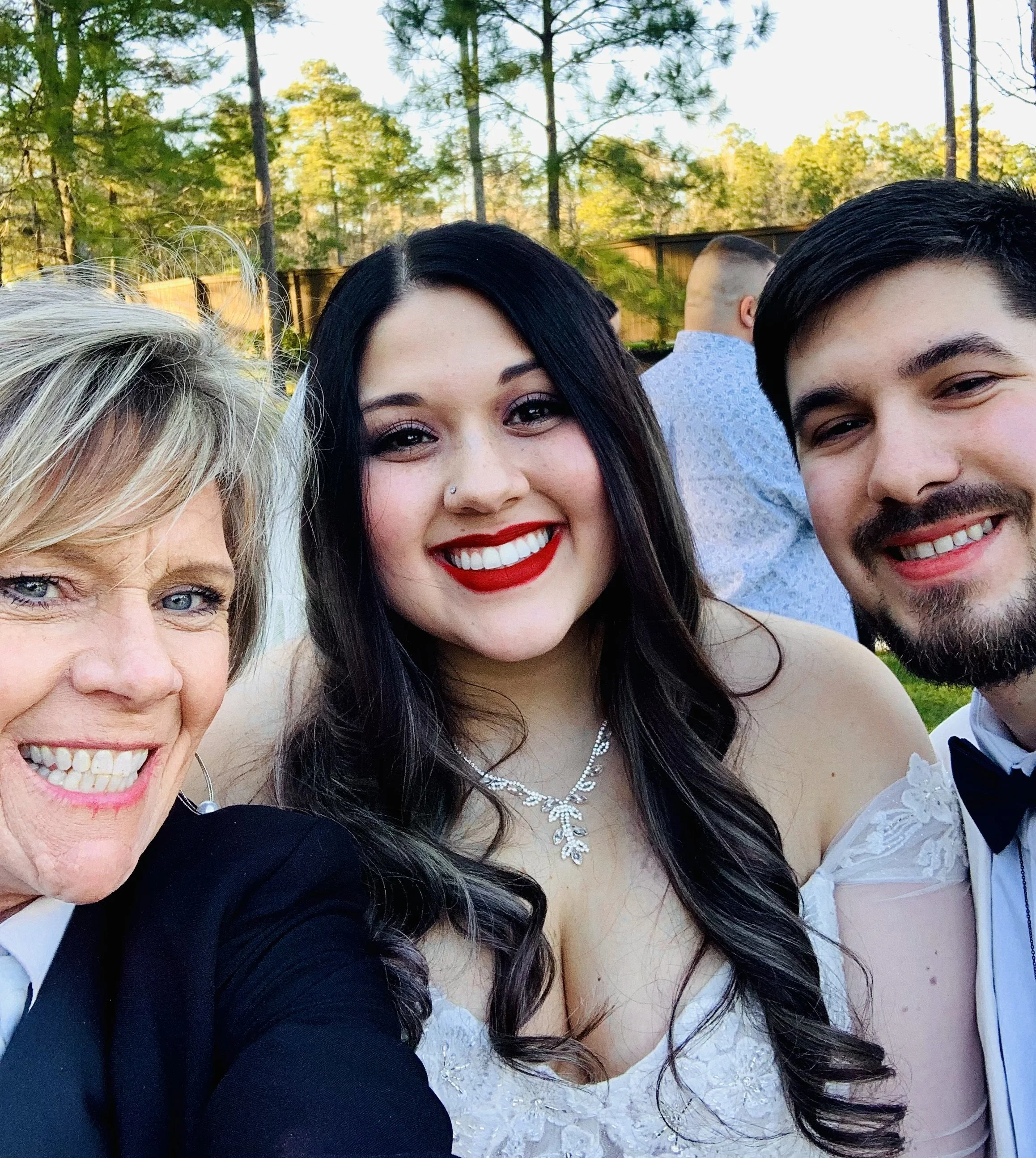 Close-up of smiling Bride & Groom & Keepsake & Co. Events Officiant, Teresa Medina,  celebrating their wedding day.