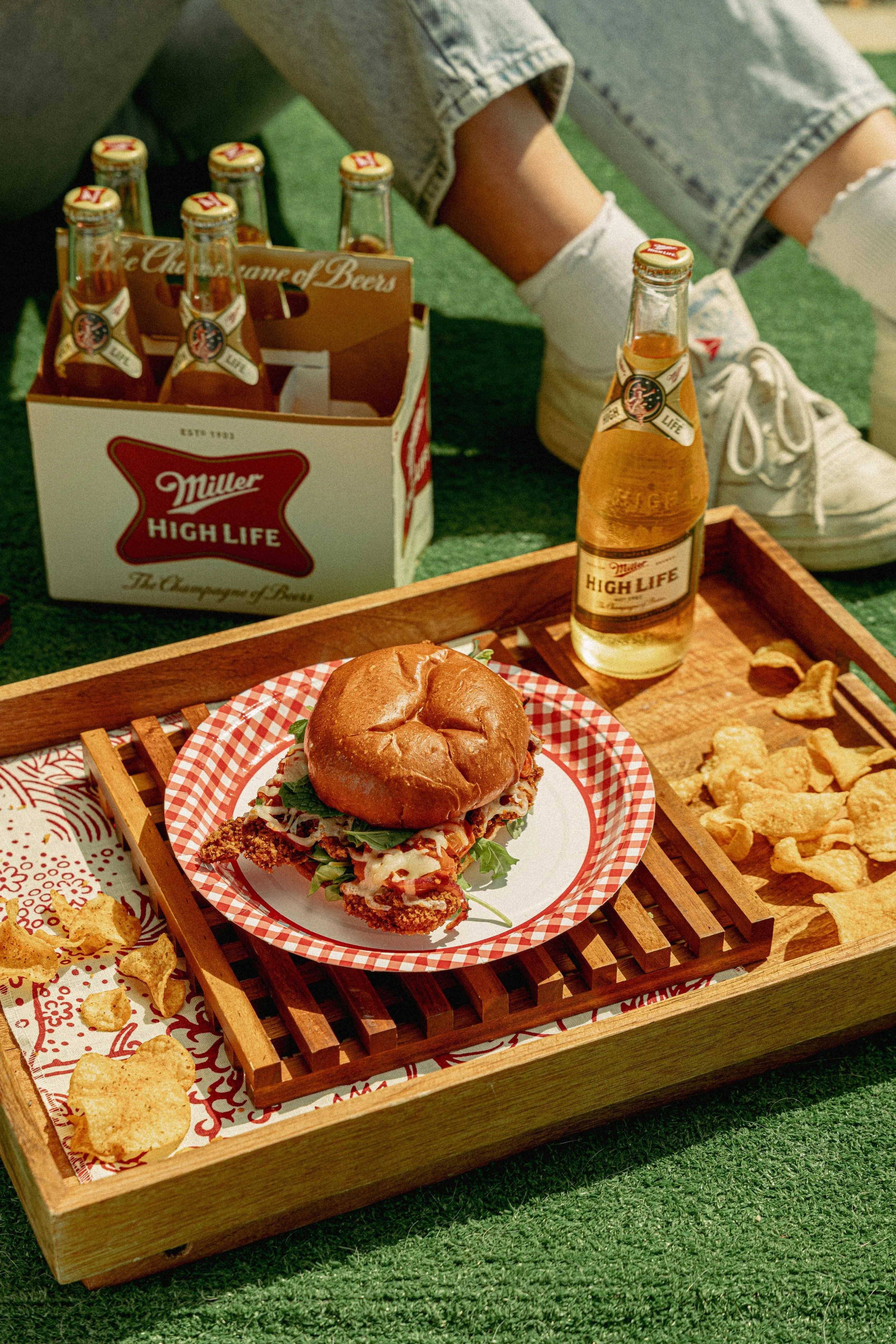 Shindig picnic spread with Fried Chicken Sandwich, house made chips and Miller High Life