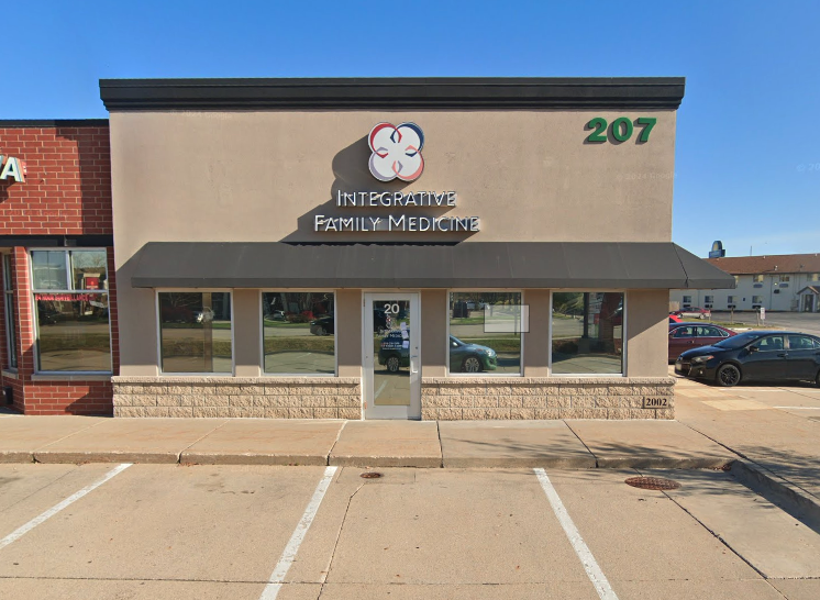 Exterior of a building with the sign 'Integrative Family Medicine' and the address '207' in the top right corner.