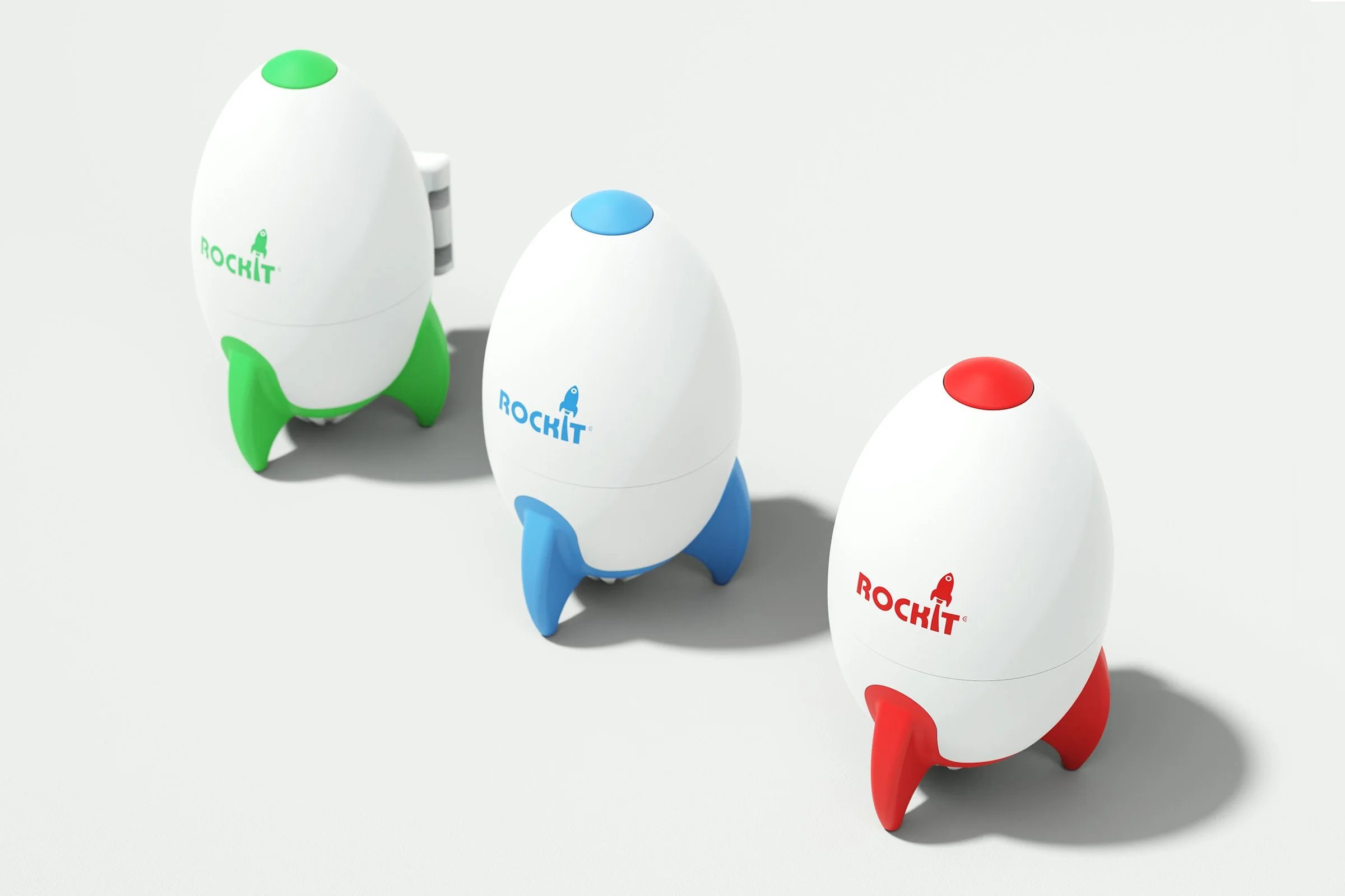 Three rocket-themed robotic toys in green, blue, and red colors arranged in a row on a white background.