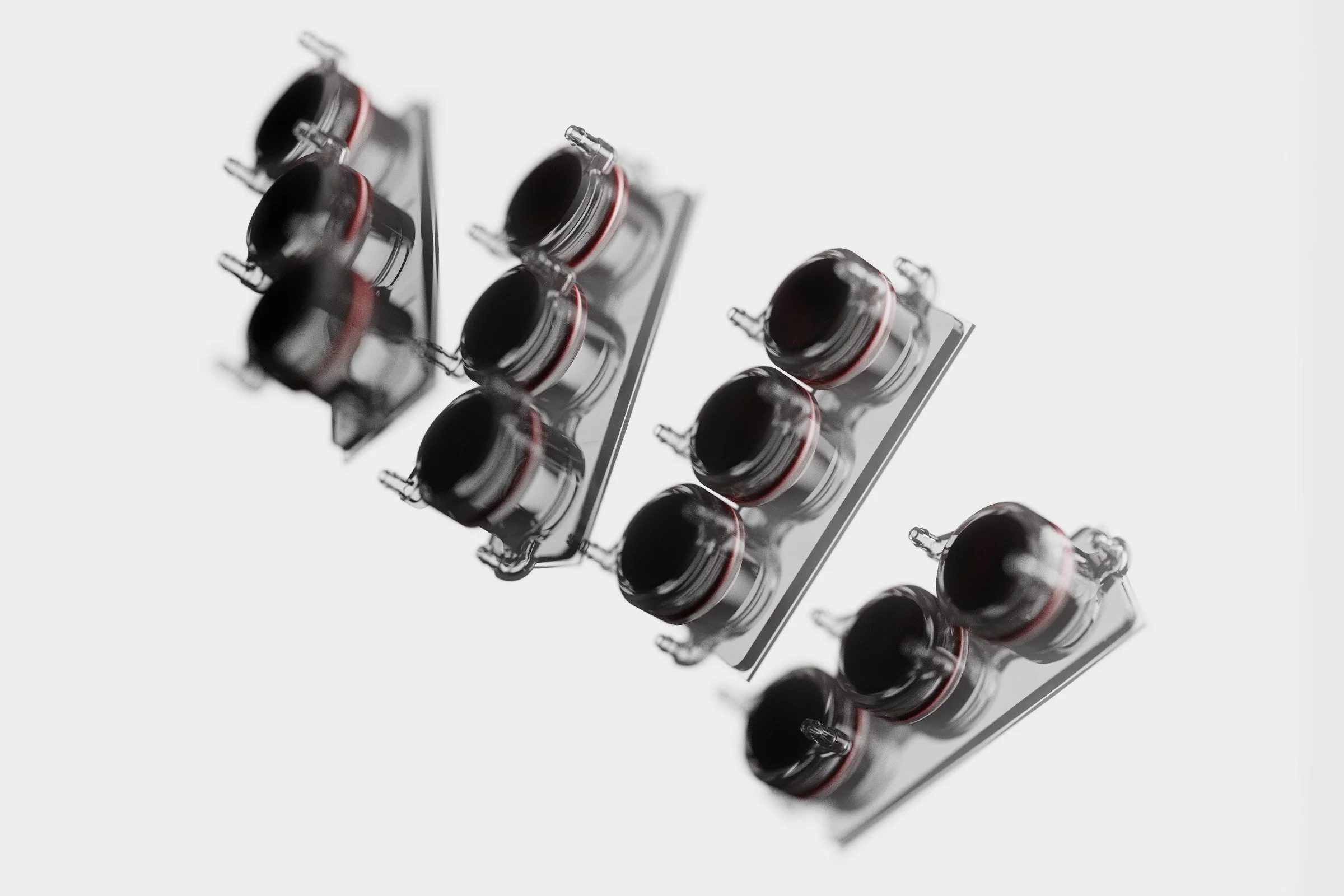 Close-up of black camera lenses on a white background.