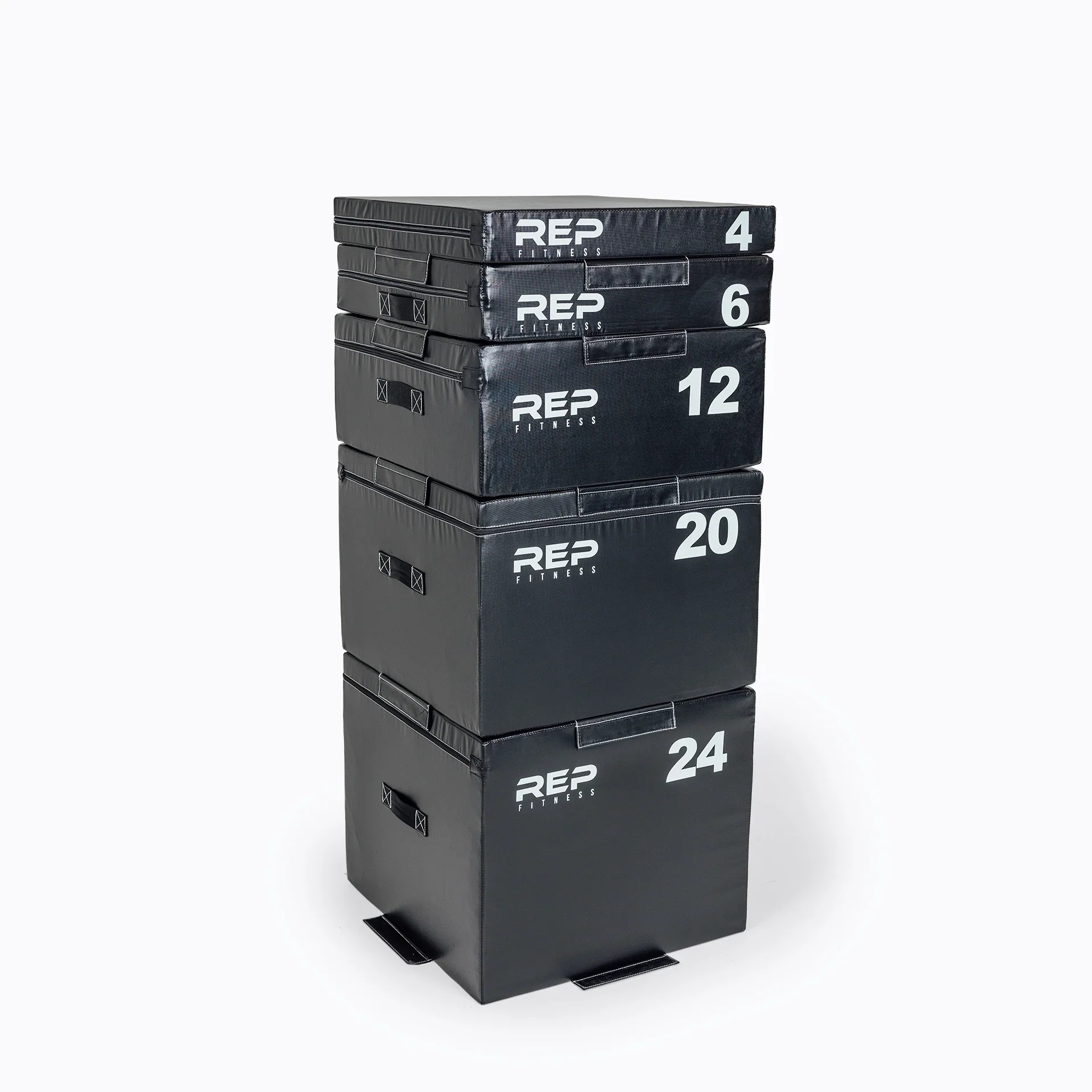 Stacked black plyometric boxes numbered 4, 6, 12, 20, and 24 for fitness exercises.