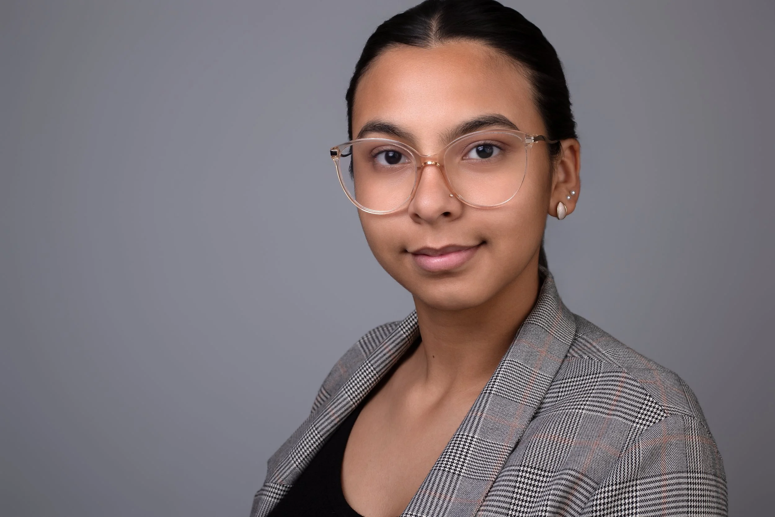 A clean and modern professional headshot photographed in Houston, Texas, featuring a polished studio portrait with soft lighting and a neutral background. Perfect for business profiles, LinkedIn, personal branding, corporate websites, and entrepreneu