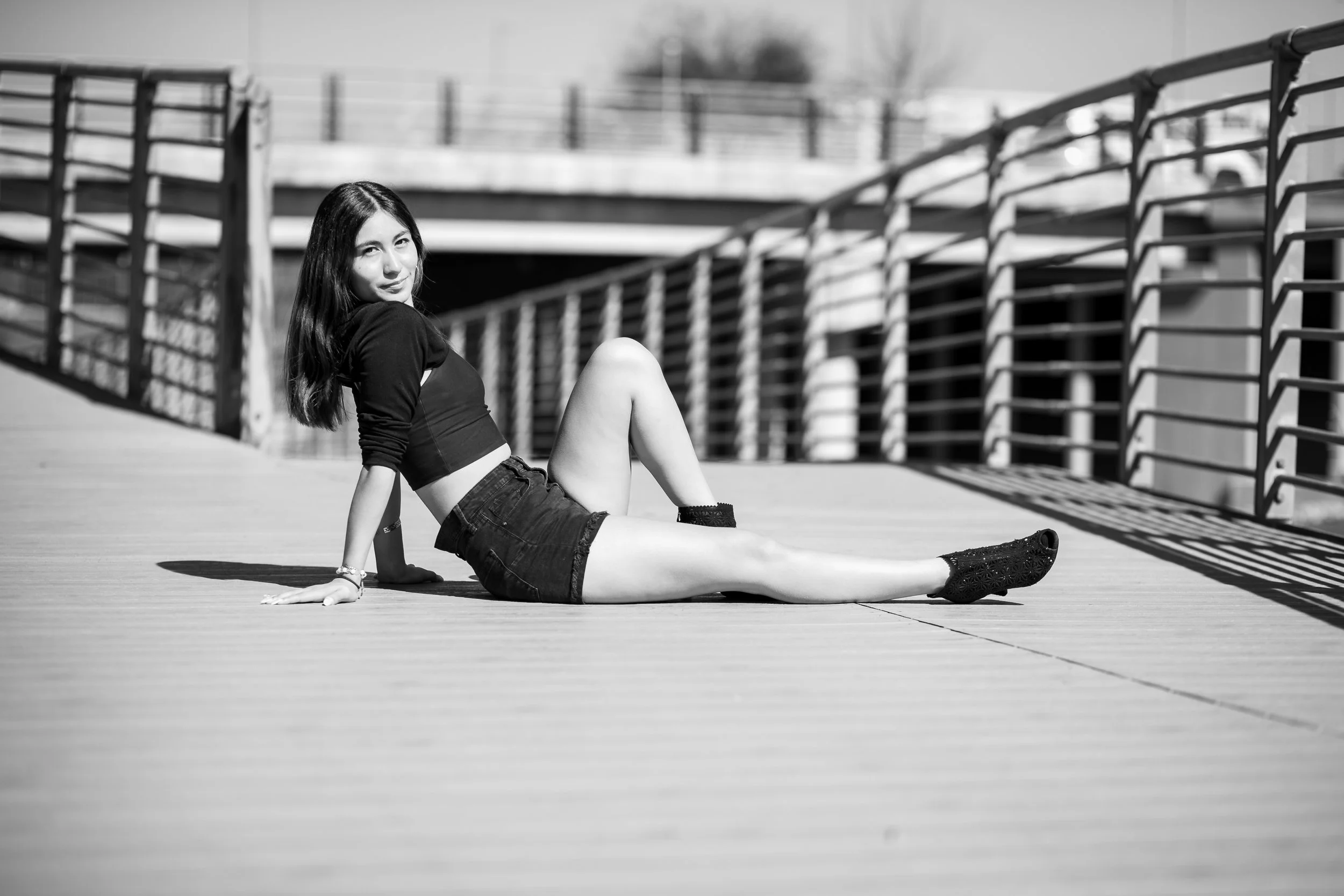 Katy high school senior photographer capturing a modern black and white outdoor senior session with confident full-body posing.