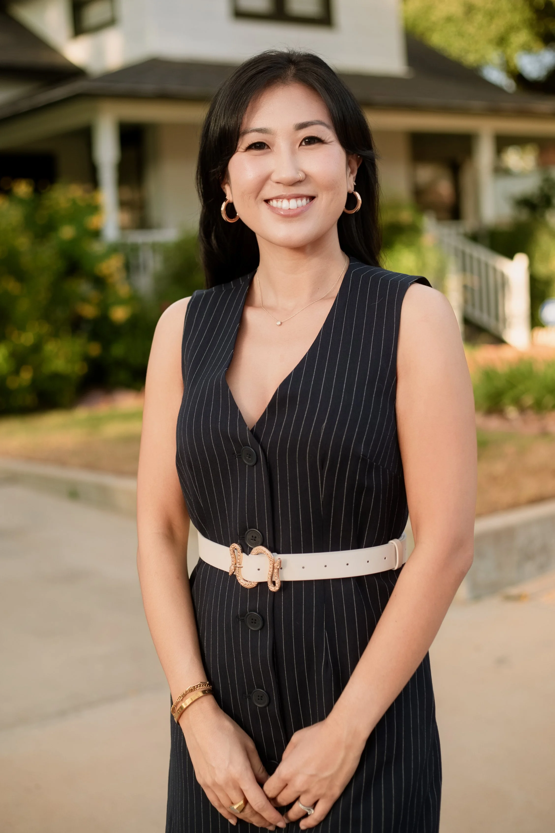 Lifestyle branding portrait featuring a confident professional woman photographed outdoors in a warm, natural neighborhood setting. Personal brand and business photography by Dominic Alvarez Photography serving Houston, Katy, and surrounding areas ac