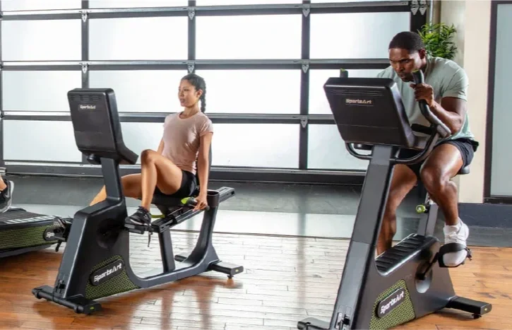 MD BioTek, Inc. | Trusted Physical Therapy and Medical Equipment Service | A man and a woman exercising on stationary bikes in a gym.