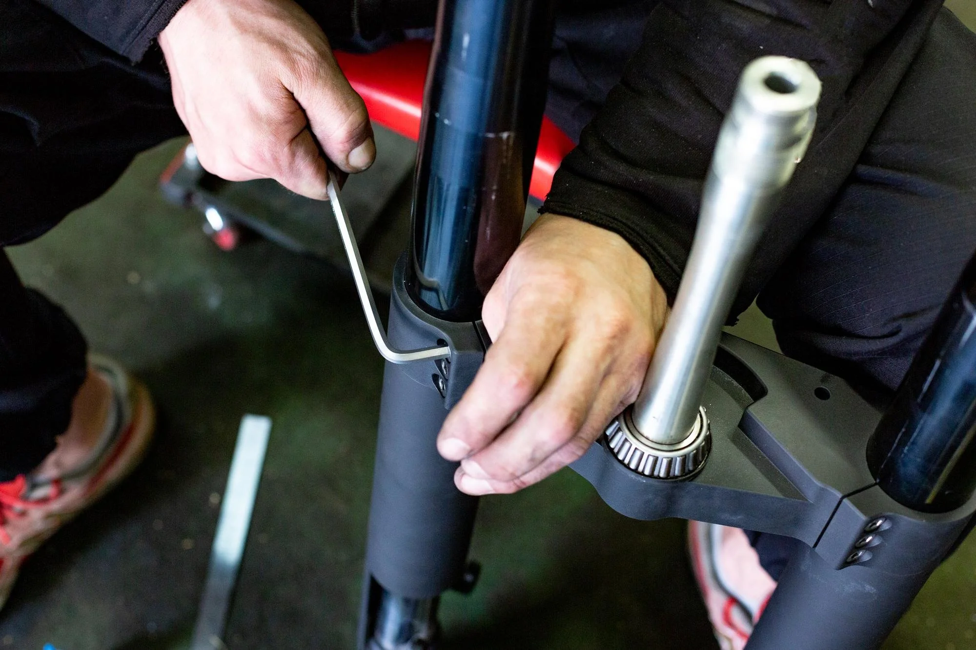 Aerson assembling a bicycle front fork, using a tool to tighten or loosen a component. | MD BioTek, Inc. | Trusted Physical Therapy and Medical Equipment Service in Carrollton ,TX