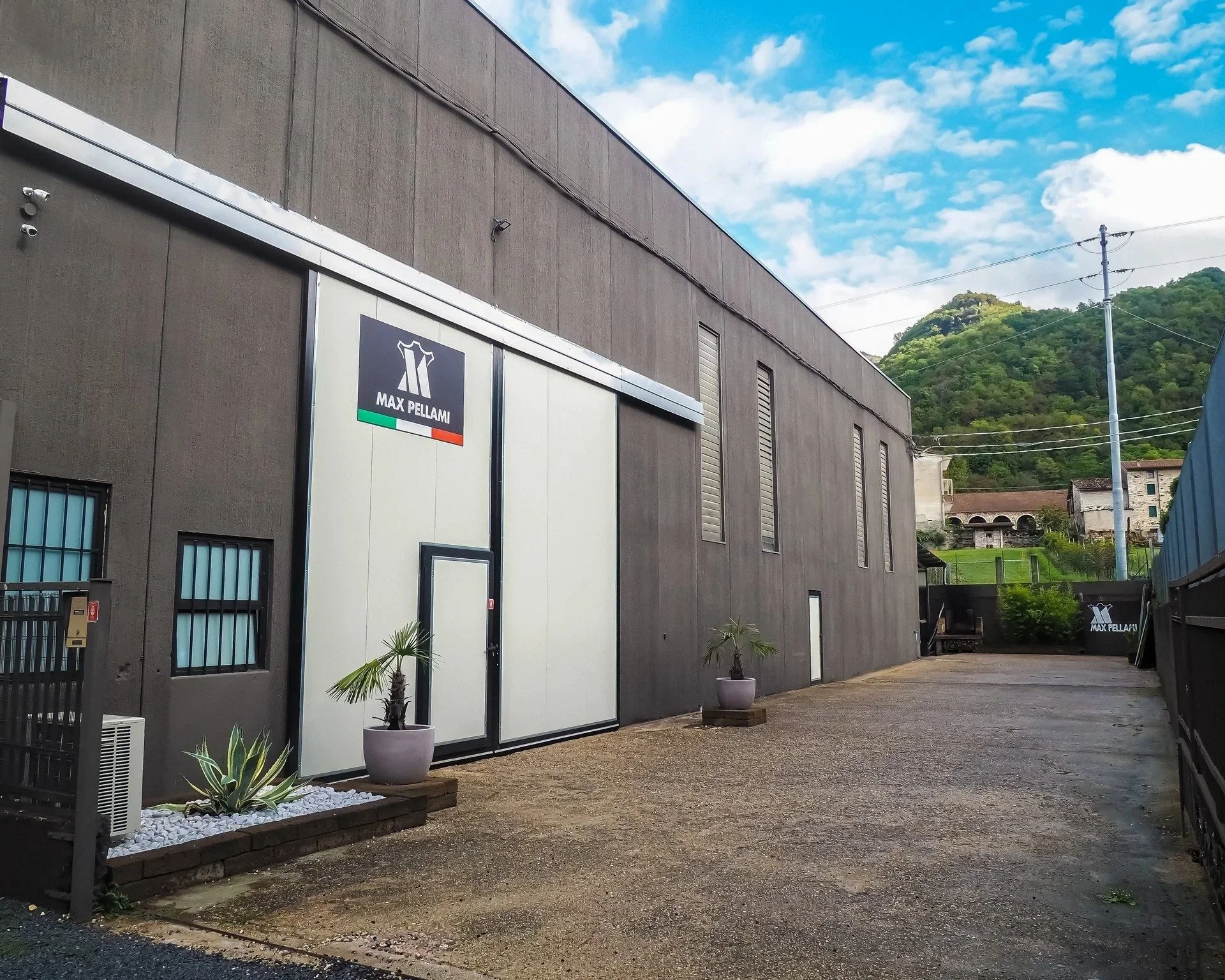 Edificio industrial con logo Max Pellami