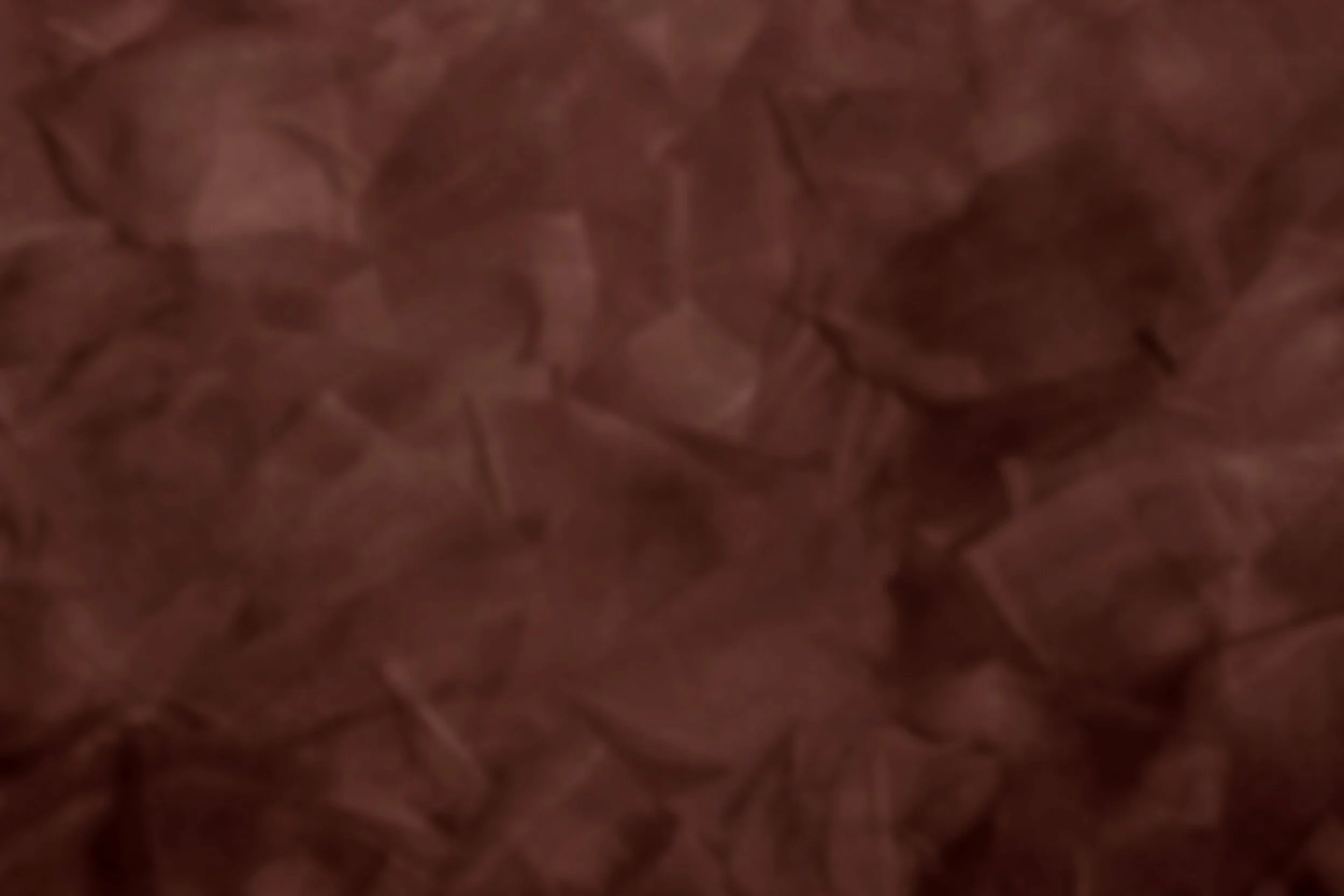 Close-up of crumpled brown paper with visible creases and folds.