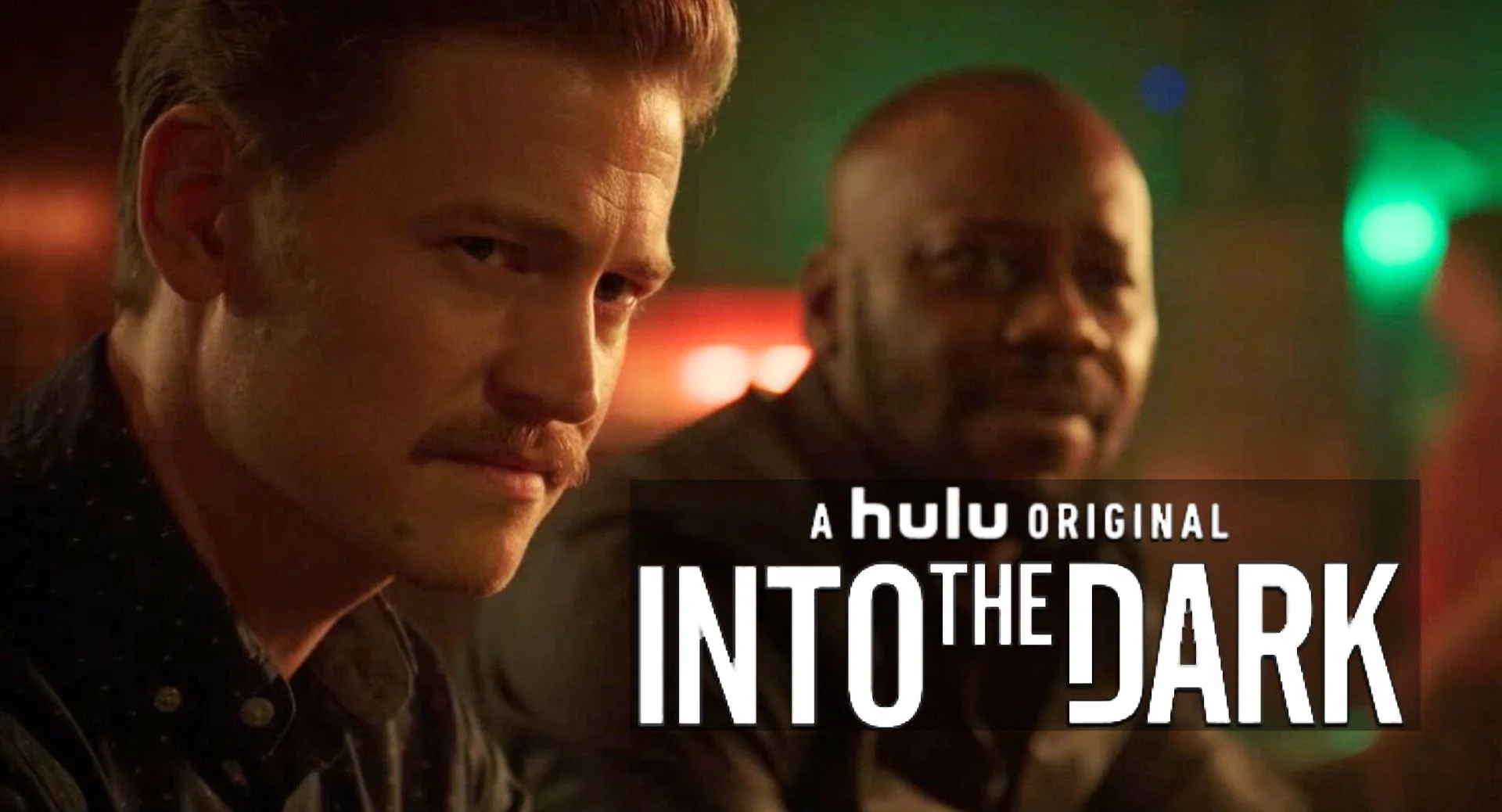 Close-up of two men at a bar with neon lights, one with red hair and beard, and another bald with a mustache, with text overlay saying 'A Hulu Original Into the Dark'.