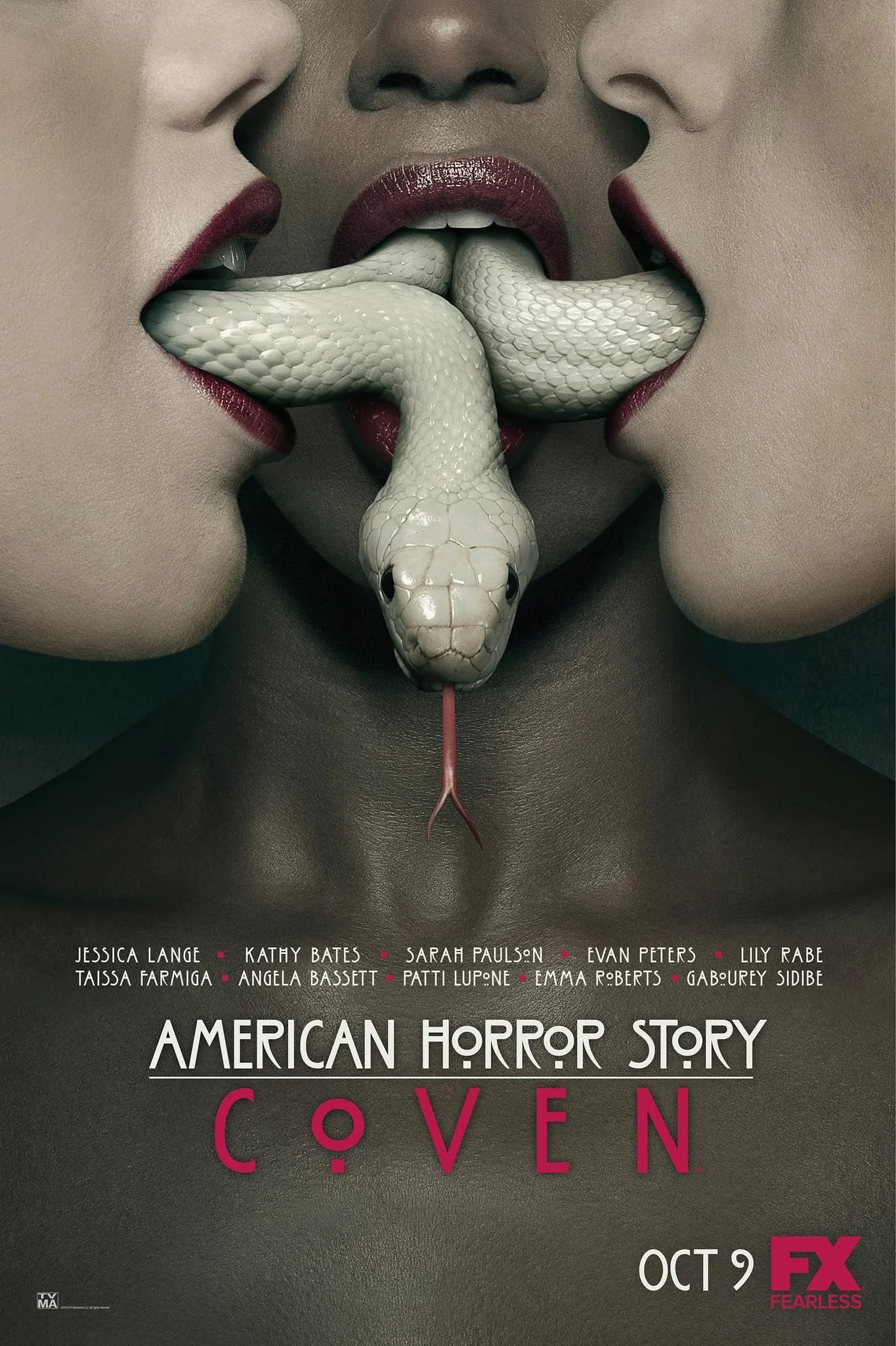 A promotional poster for the TV series 'American Horror Story: Coven,' showing three women with lipstick kissing a white snake with its tongue out, surrounded by text with cast names and show details.