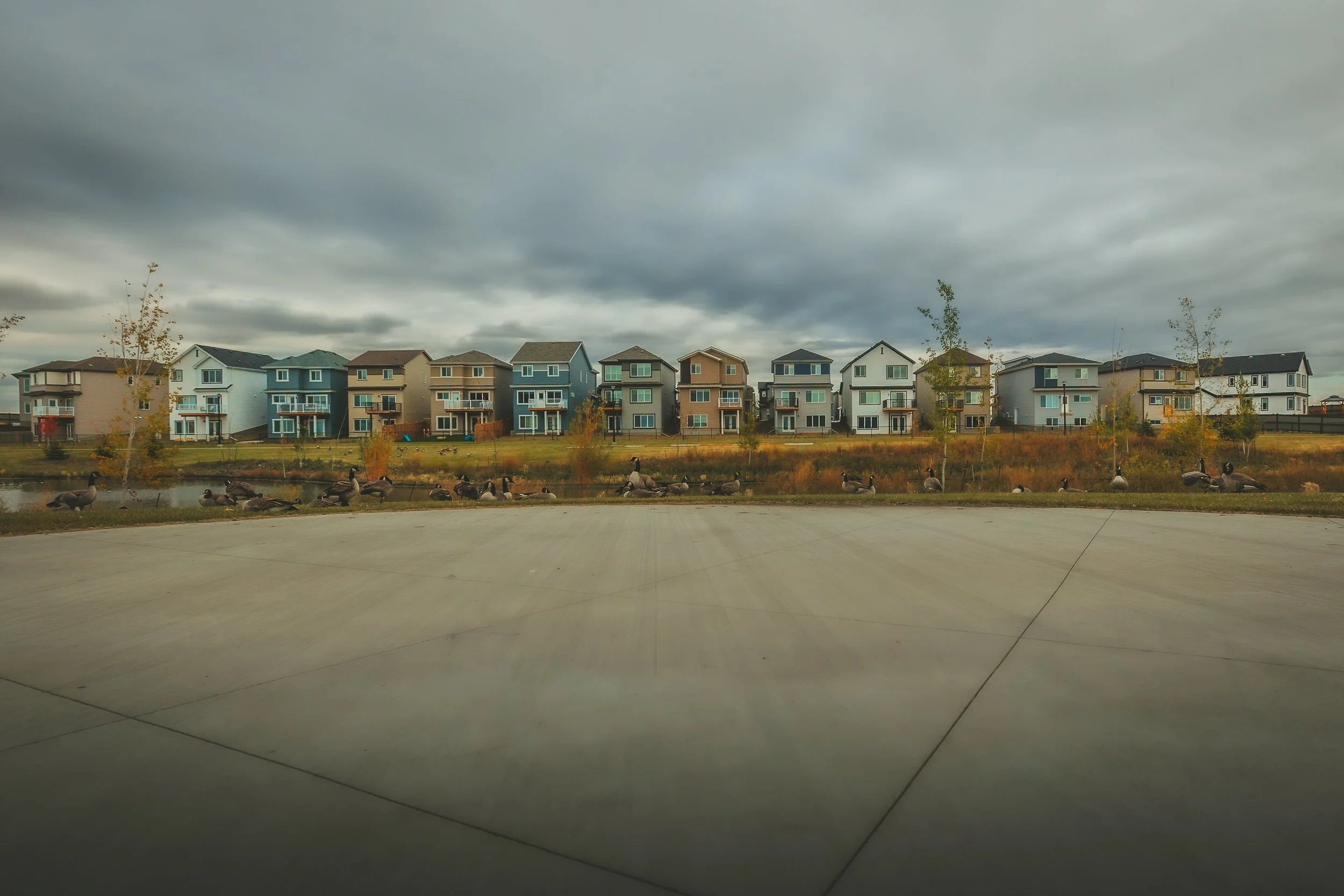 Row of modern homes along a walkway in Le Rêve in Beaumont, AB