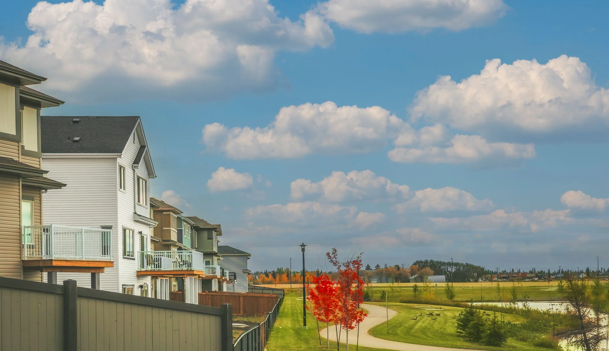 Row of modern homes along a walkway in Le Rêve in Beaumont, AB