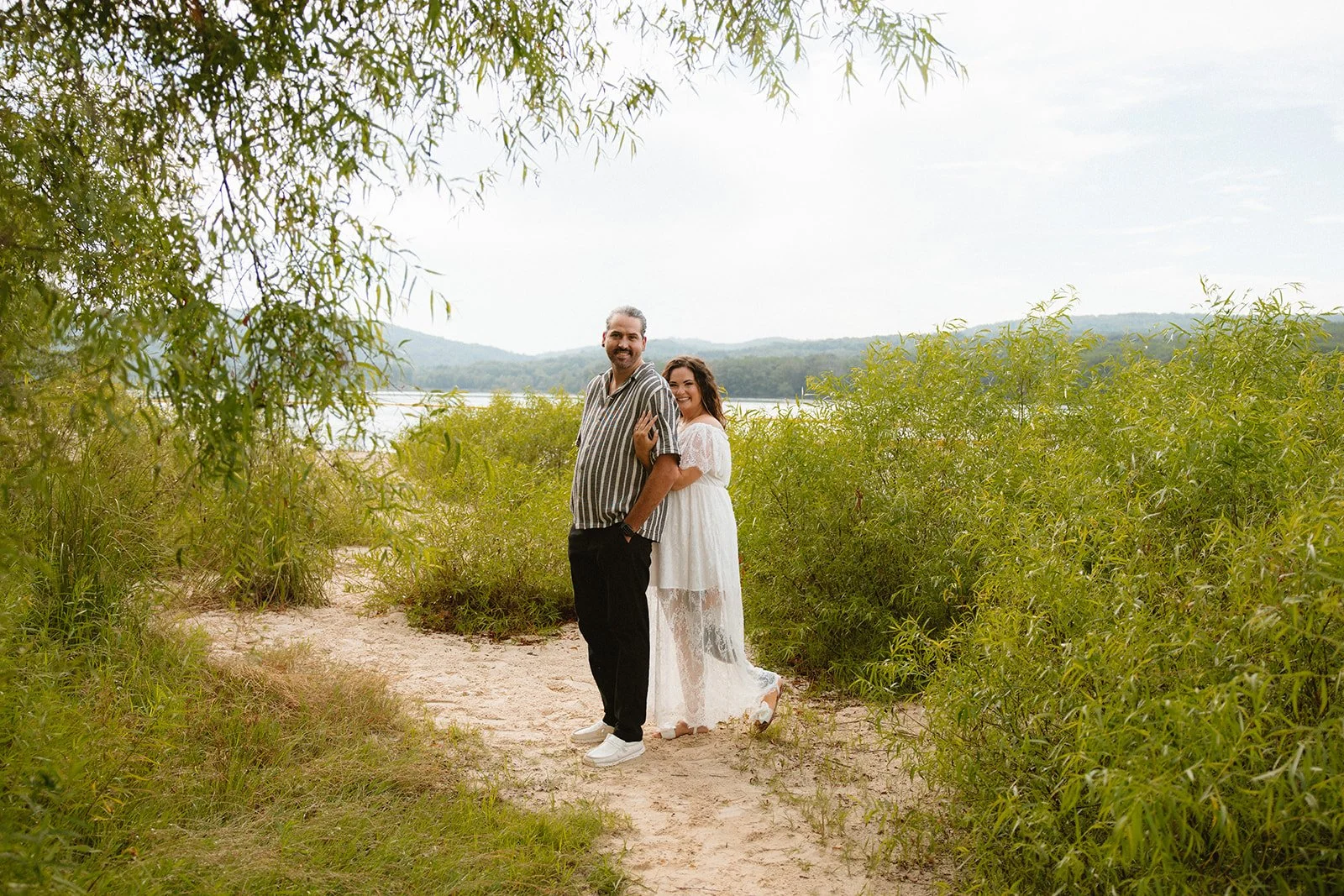 Couple embracing each other on the beach at Yellow Creek State Park.
