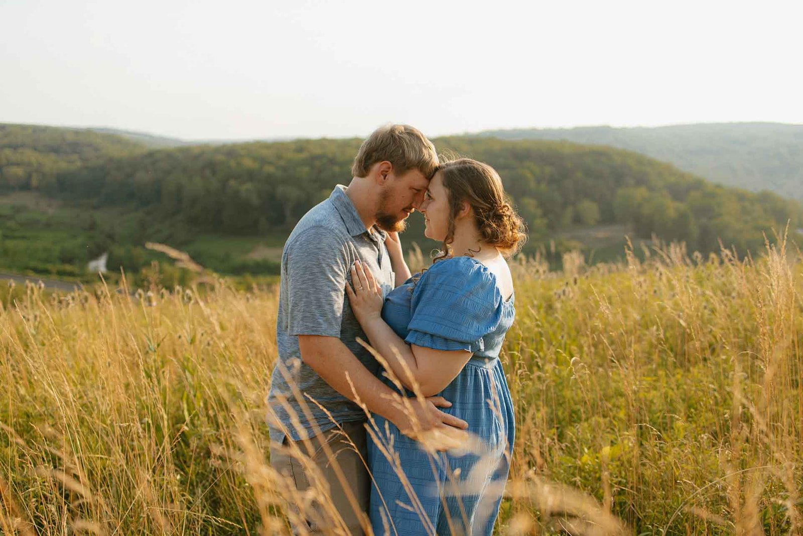 engaged couple holding each other in a field at Johnstown Flood National Memorial