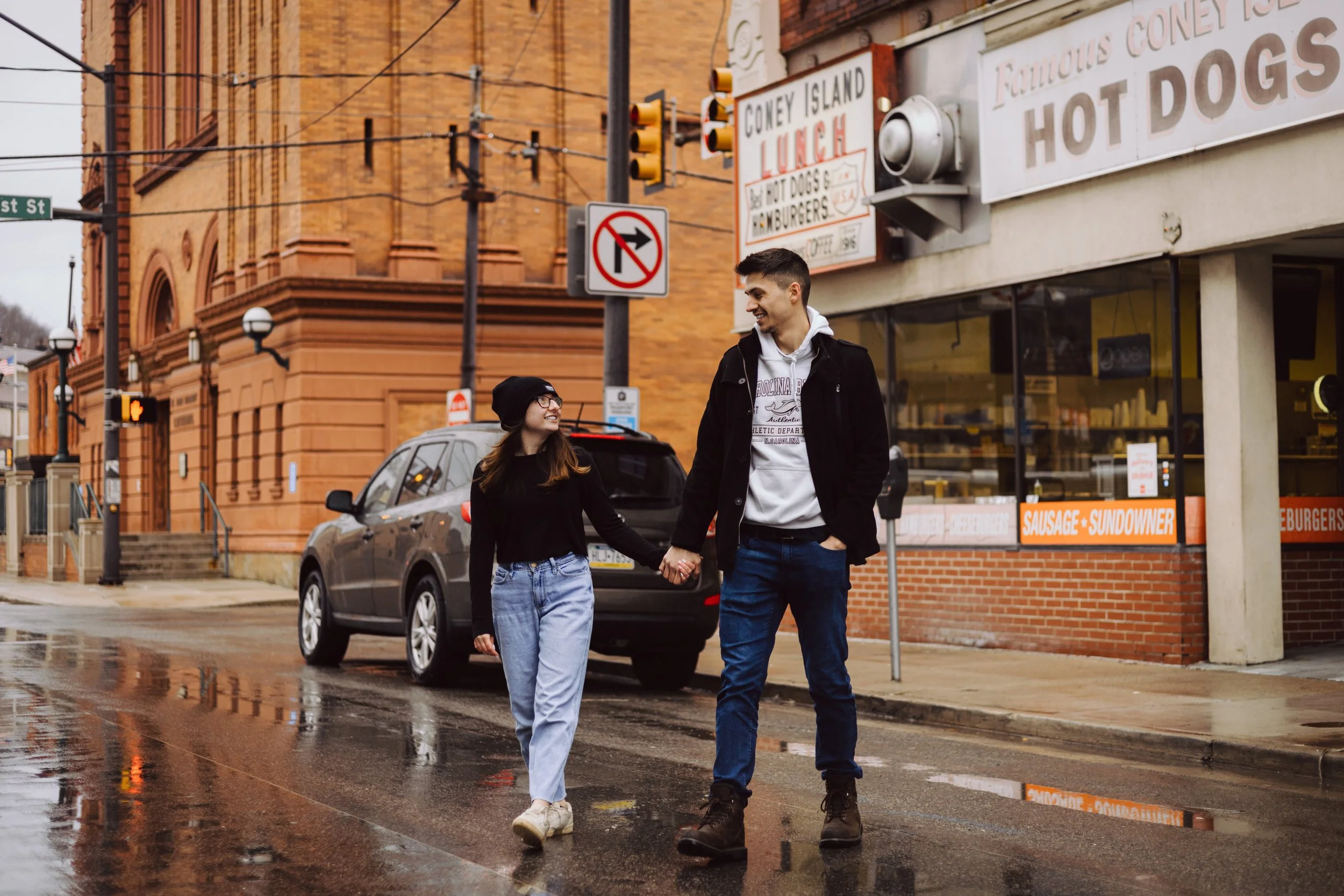 Couple smiling and walking the streets of downtown Johnstown near Coney Island.