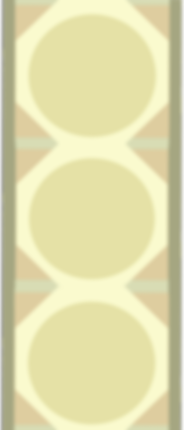 A blurry image of a vertical structure with three large yellowish circles aligned vertically in the center.