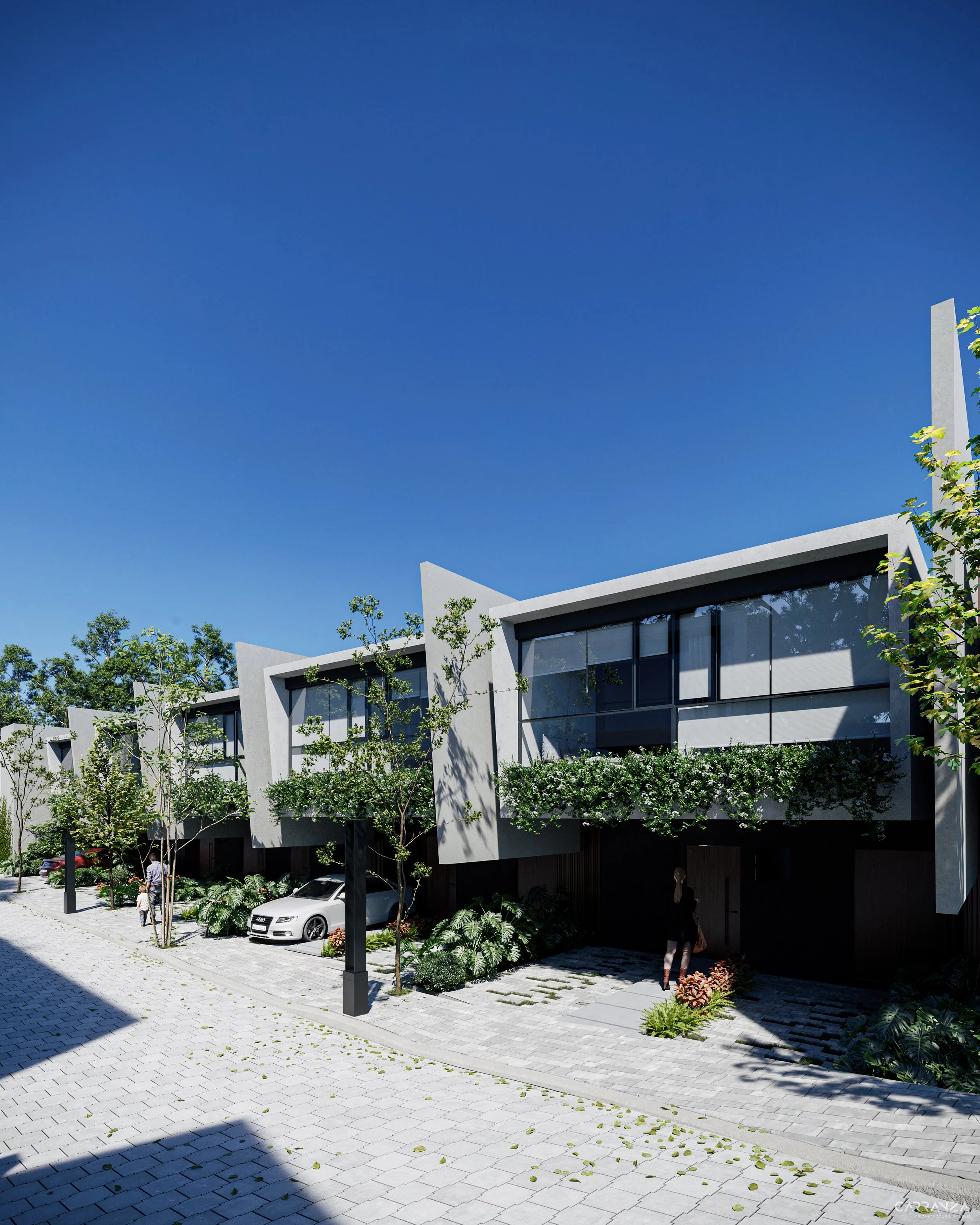 Conjunto de casas modernas con fachadas de vidrio y techos inclinados, rodeadas de árboles y plantas, en un día soleado.