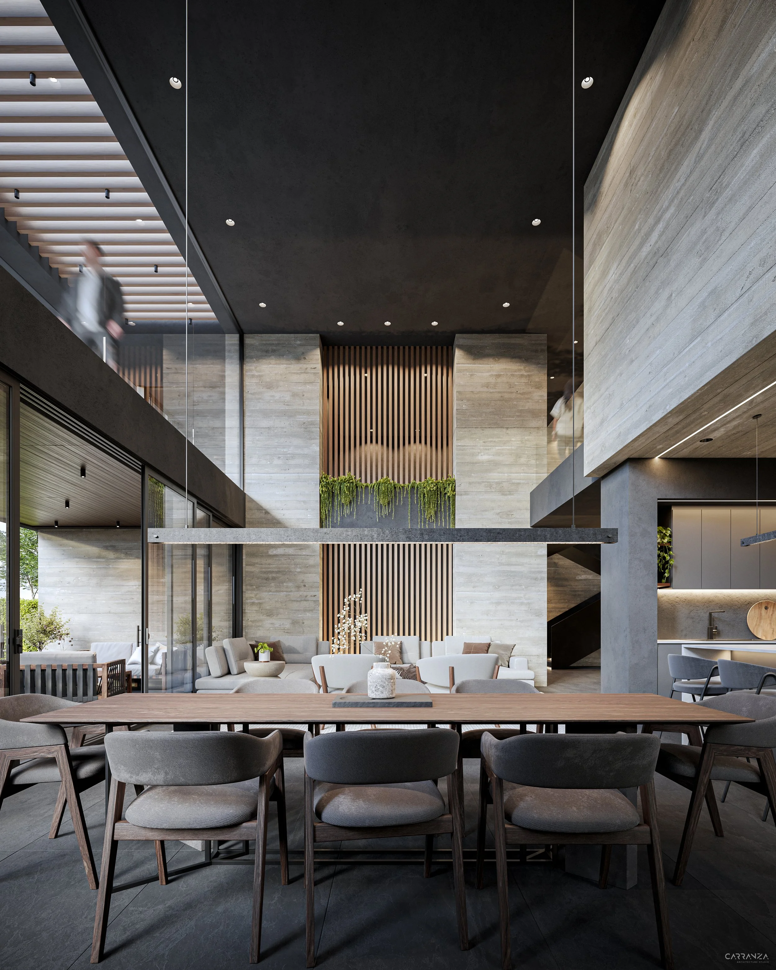 Interiores de un moderno comedor con mesa de madera y sillas de tela gris, paredes de piedra y elementos decorativos verdes, en un ambiente amplio y con mucha luz natural.