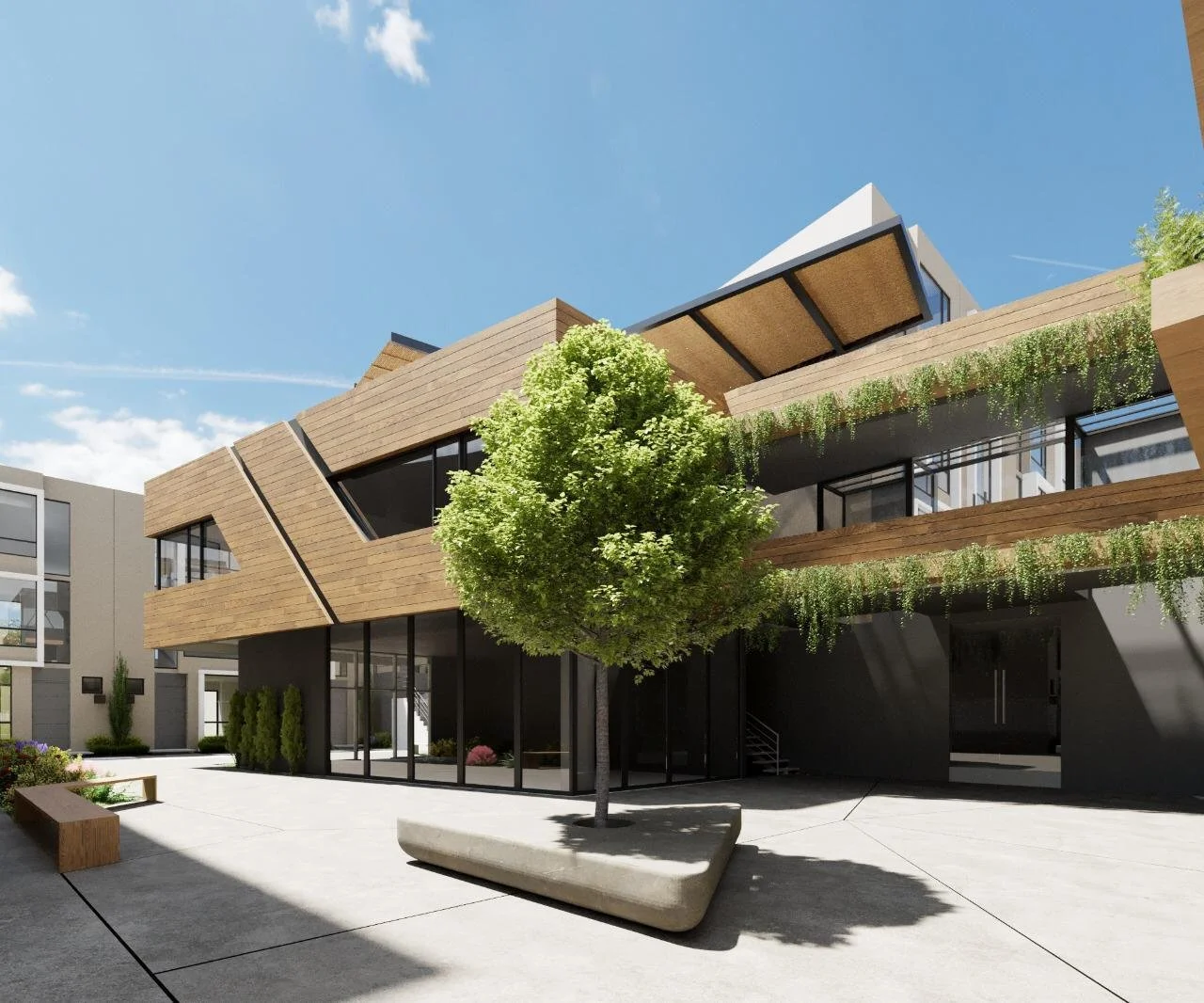 Edificio moderno de múltiples niveles con diseño innovador, en el centro hay un árbol y un banco de concreto, con cielo claro y nubes al fondo.