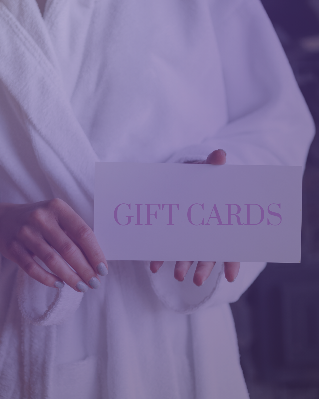 Person holding a white envelope with the words 'GIFT CARDS' written on it.