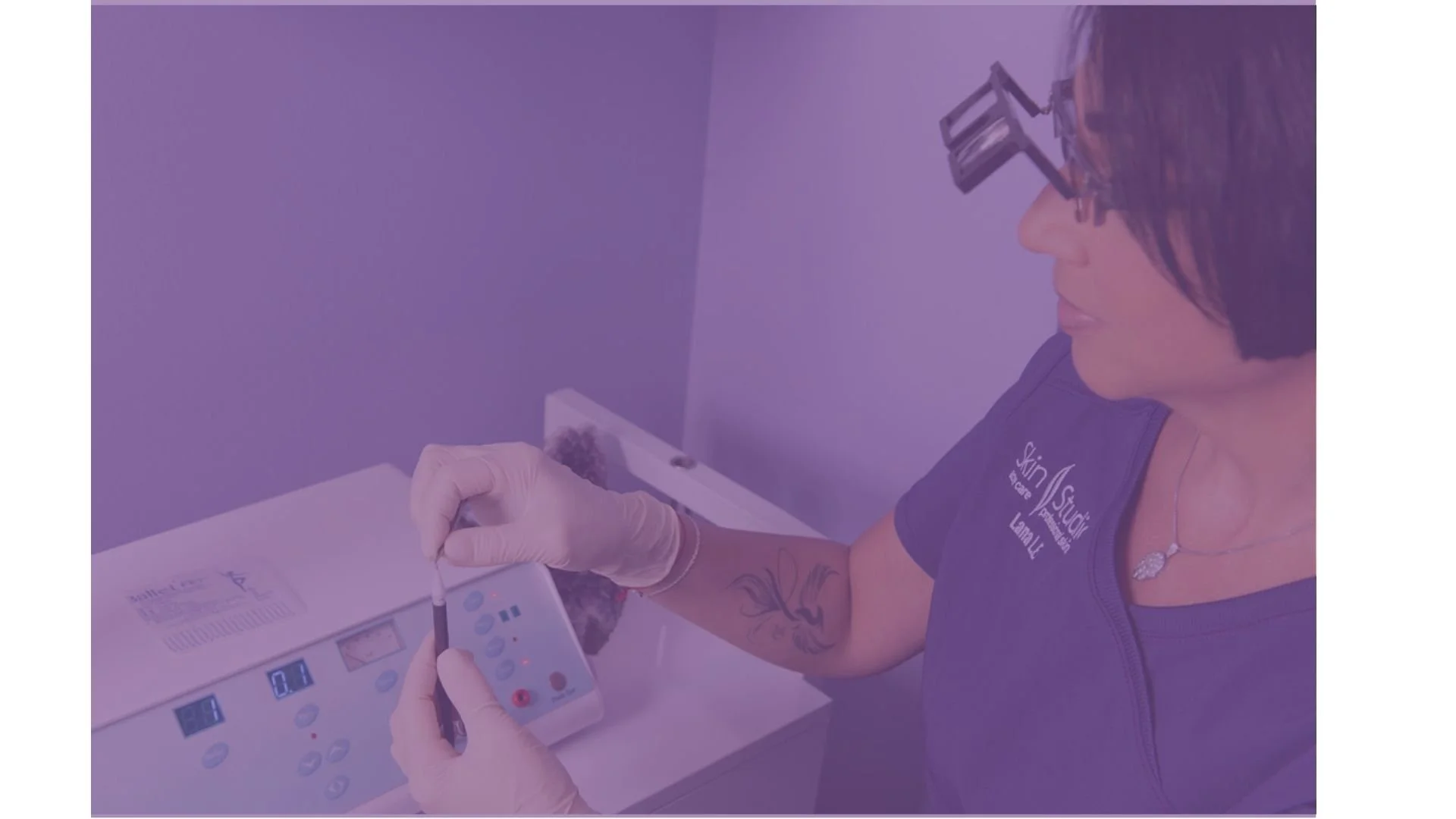 A registered electrologist holding an electrolysis probe