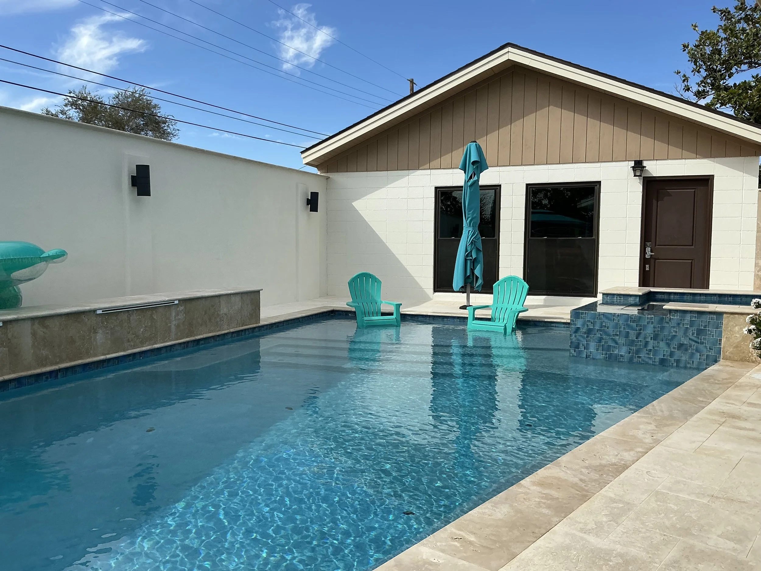 Residential backyard pool with spa and water features maintained by Tech & Pool Services by Emmanuel in Midland, Texas