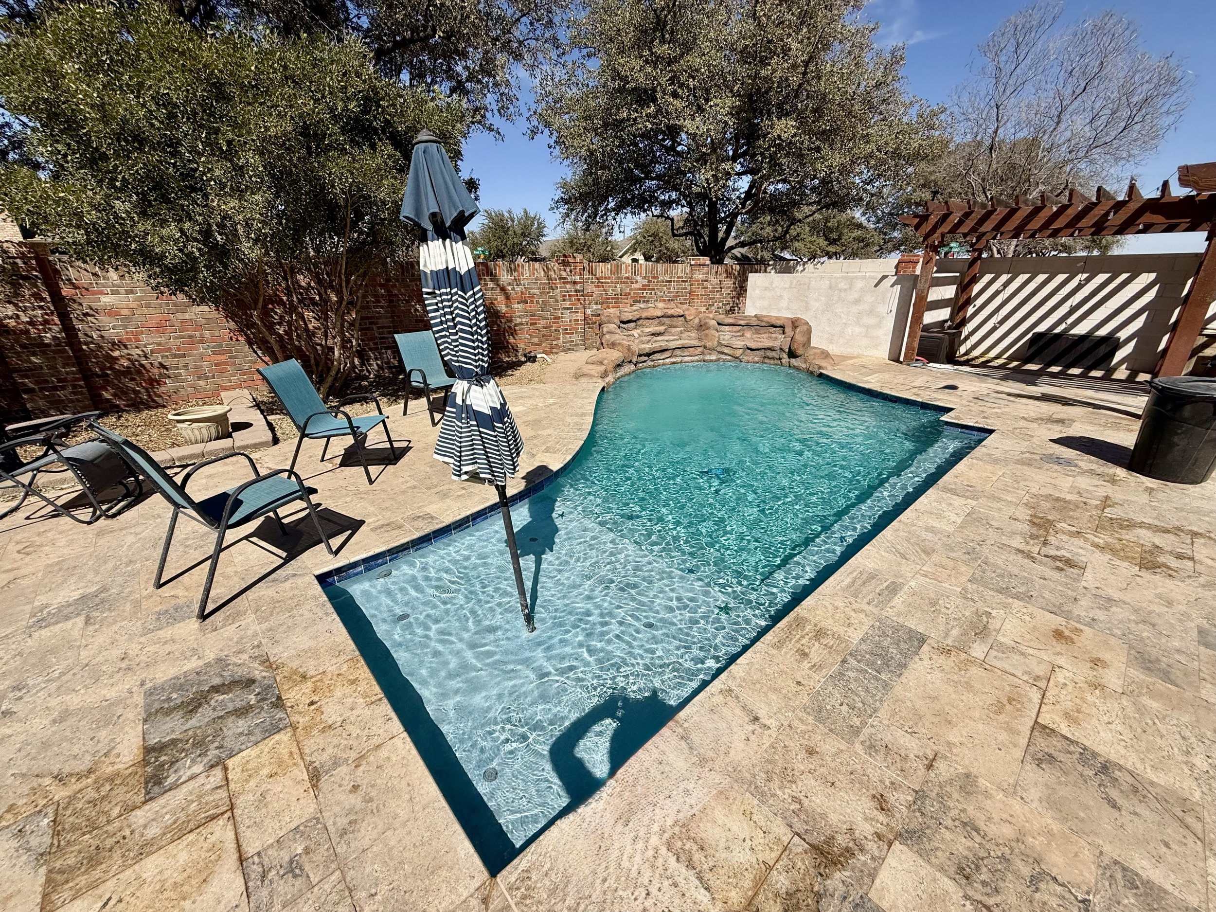 Residential pool in Midland, TX after cleaning, with clear water and clean tile.