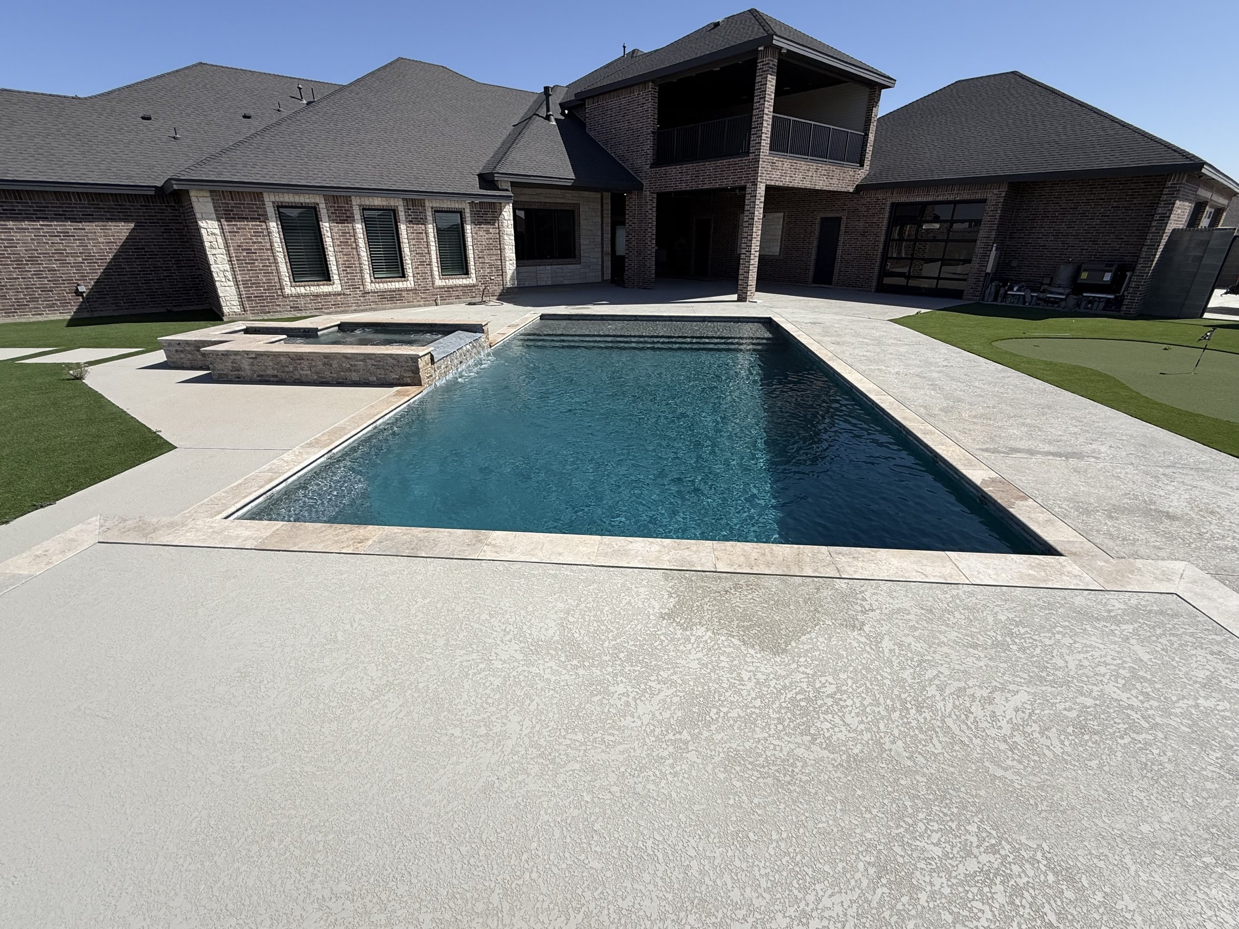 Clean residential pool with clear water following weekly maintenance in Midland, Texas.