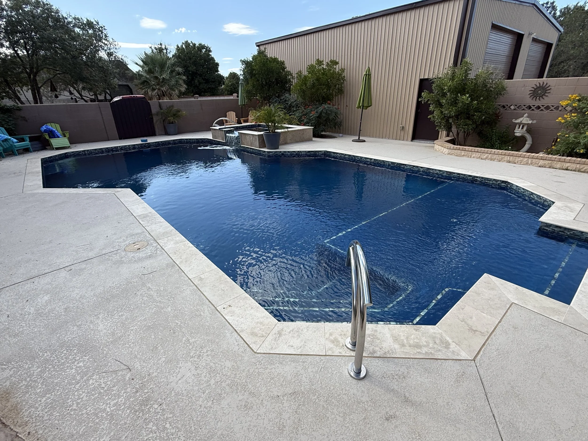 Freshly cleaned pool water in a private backyard setting.