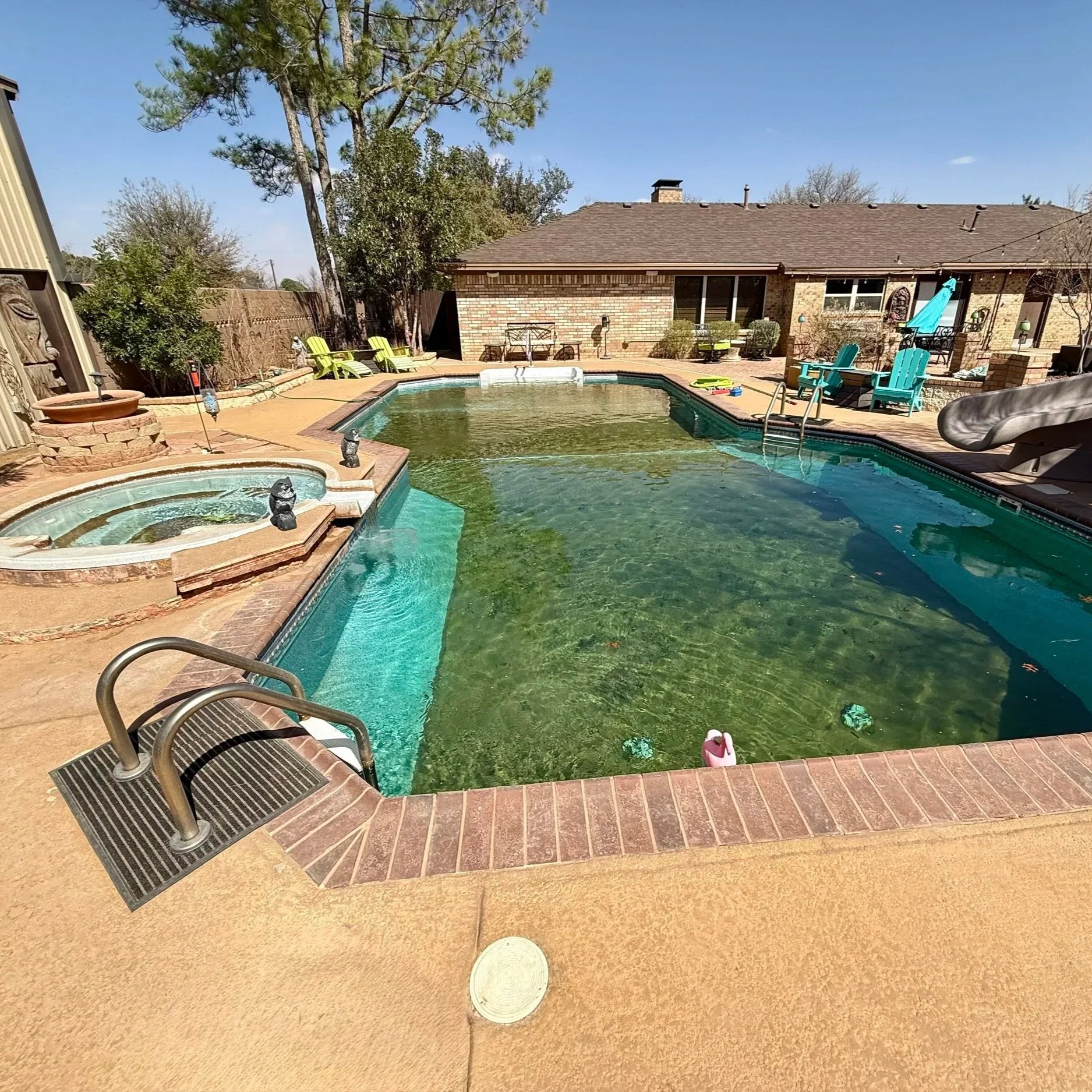 Green, algae-filled residential pool before treatment, illustrating green pool recovery and water restoration services in Midland, Texas.