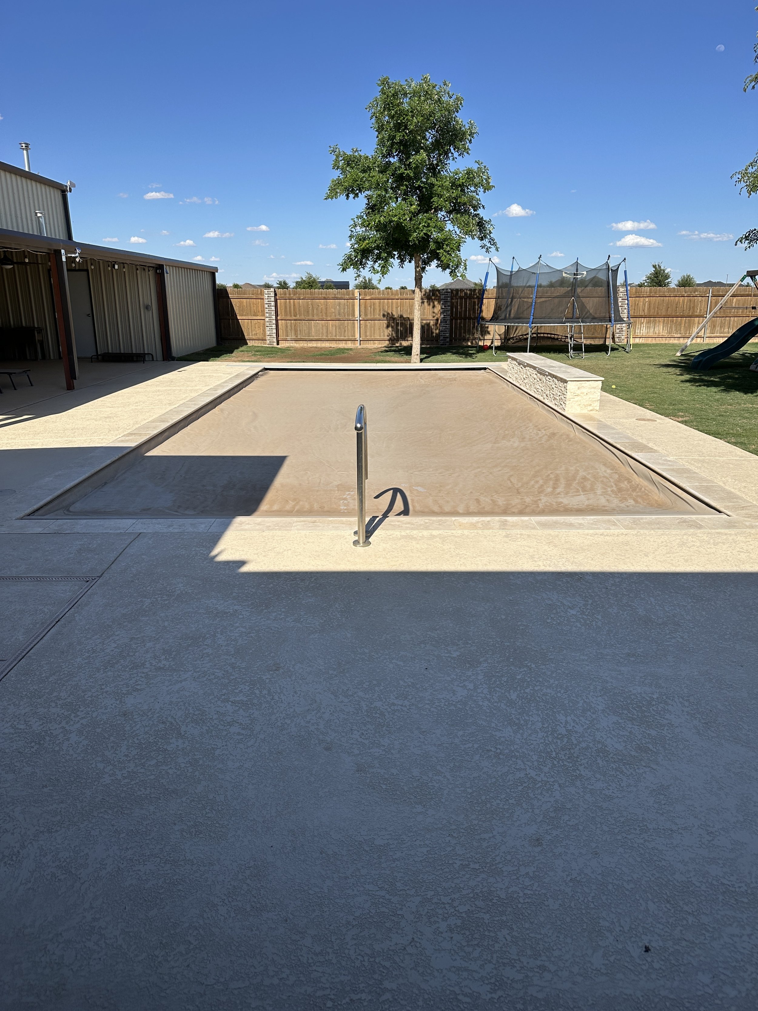 Pool covered before cleaning service at a residential home in Midland, TX.