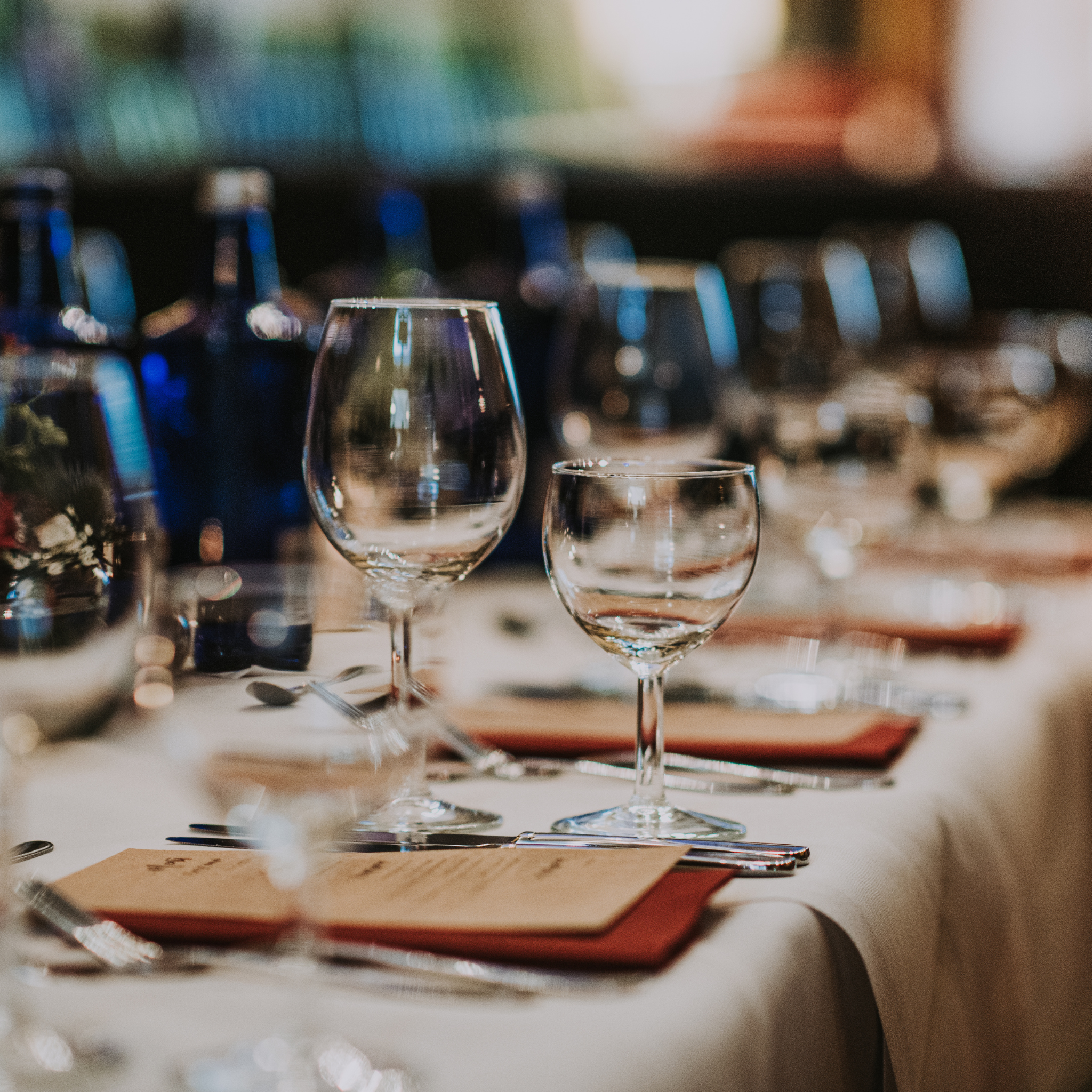wine glasses set at a nicely decorated long table