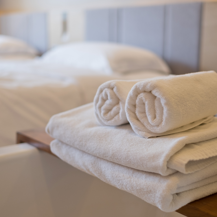 A set of white towels in a luxury hotel room.