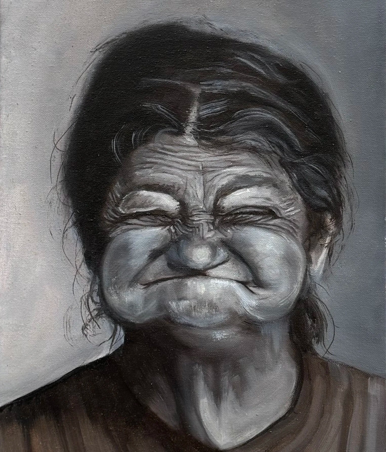 Porträt einer älteren Frau, frontal, mit offenem, leicht schelmischem Lächeln, Falten sichtbar.