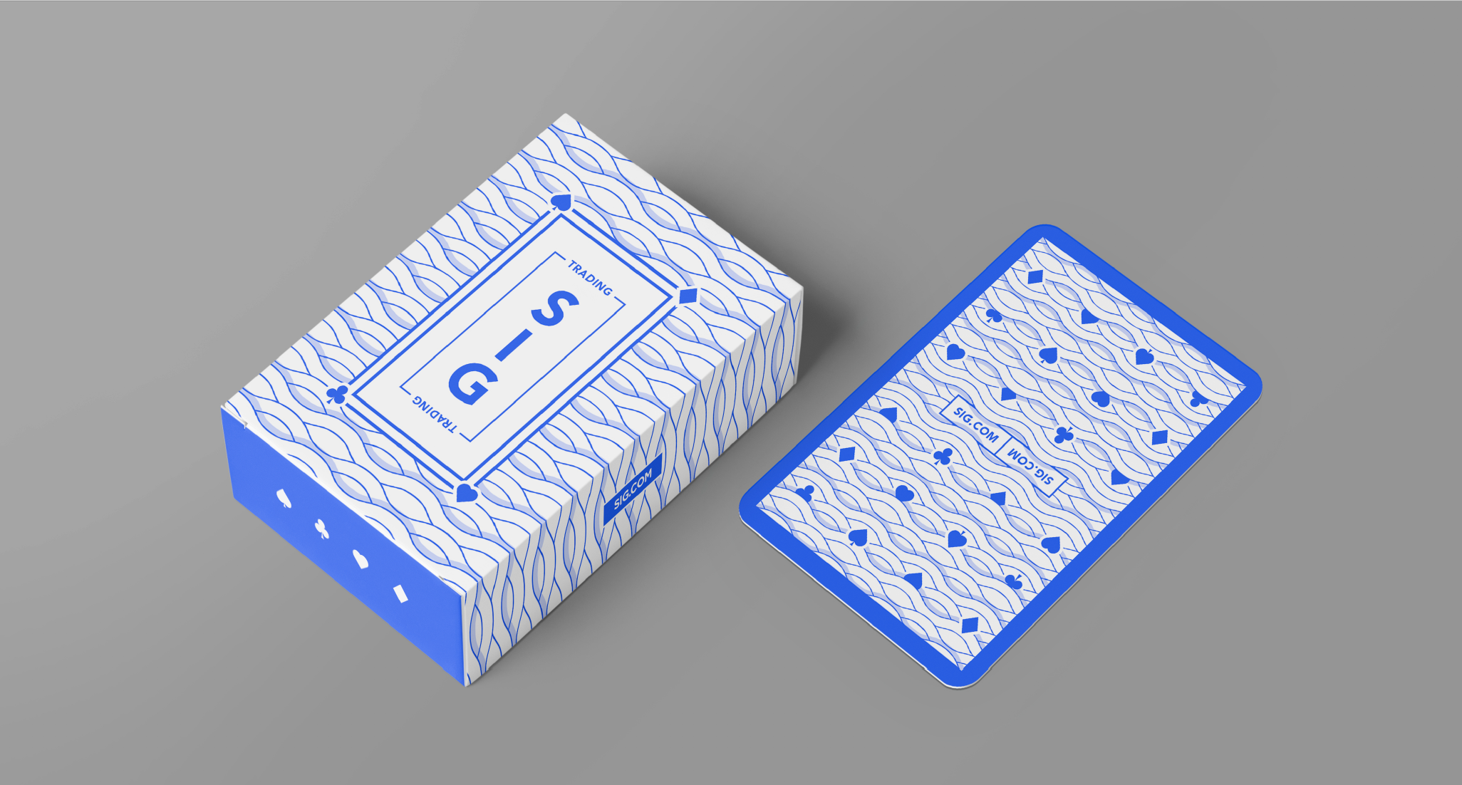 A deck of blue and white playing cards with a decorative pattern and the branding 'SIG' on the box, placed on a gray surface.